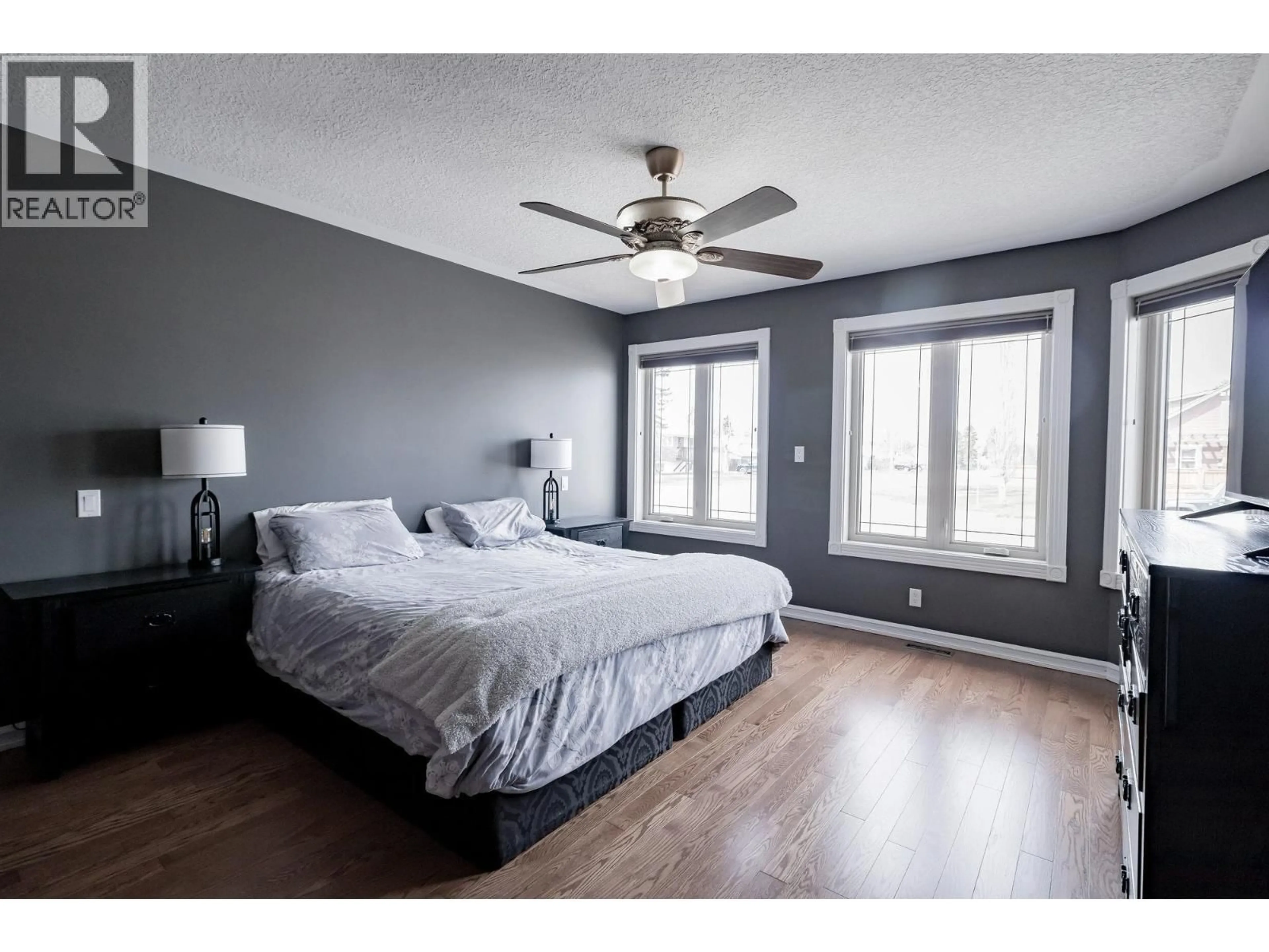 Bedroom with bed, wood/laminate floor for 8019 97 AVENUE, Fort St. John British Columbia V1J1L7