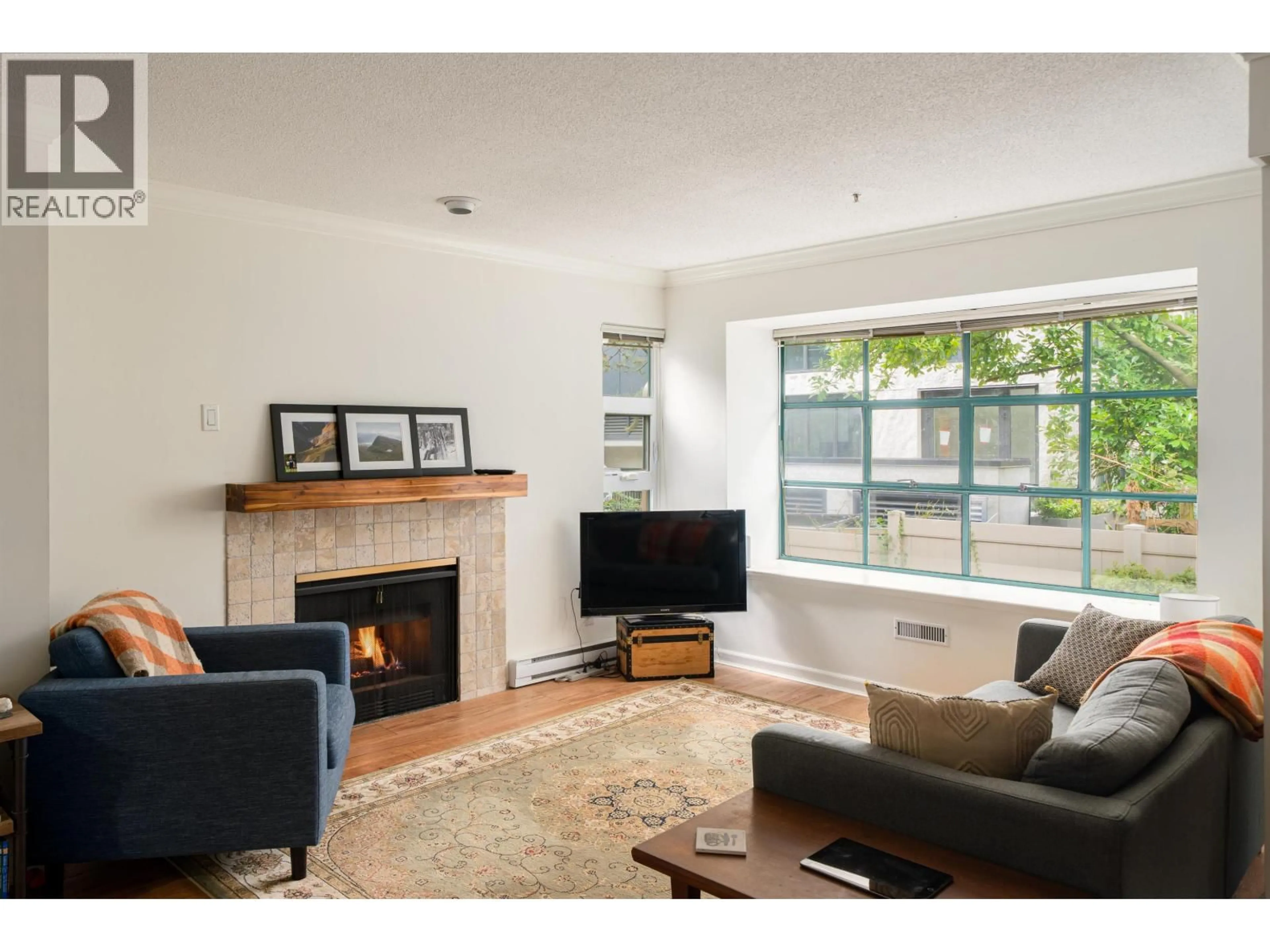 Living room with furniture, wood/laminate floor for 205 - 3788 8TH AVENUE, Vancouver British Columbia V6R1Z3