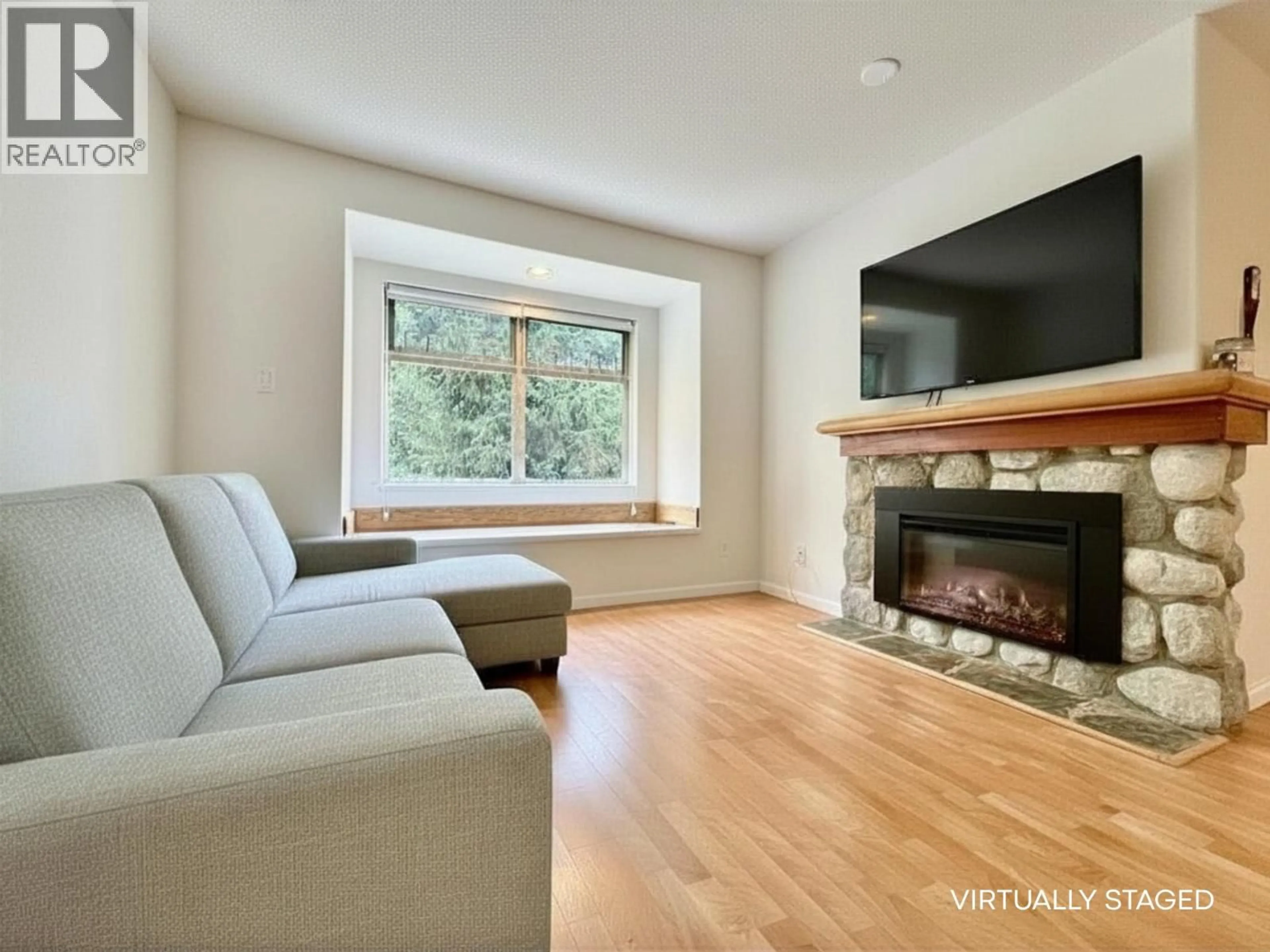 Living room with furniture, wood/laminate floor for 21 - 2050 LAKE PLACID ROAD, Whistler British Columbia V8E0A8