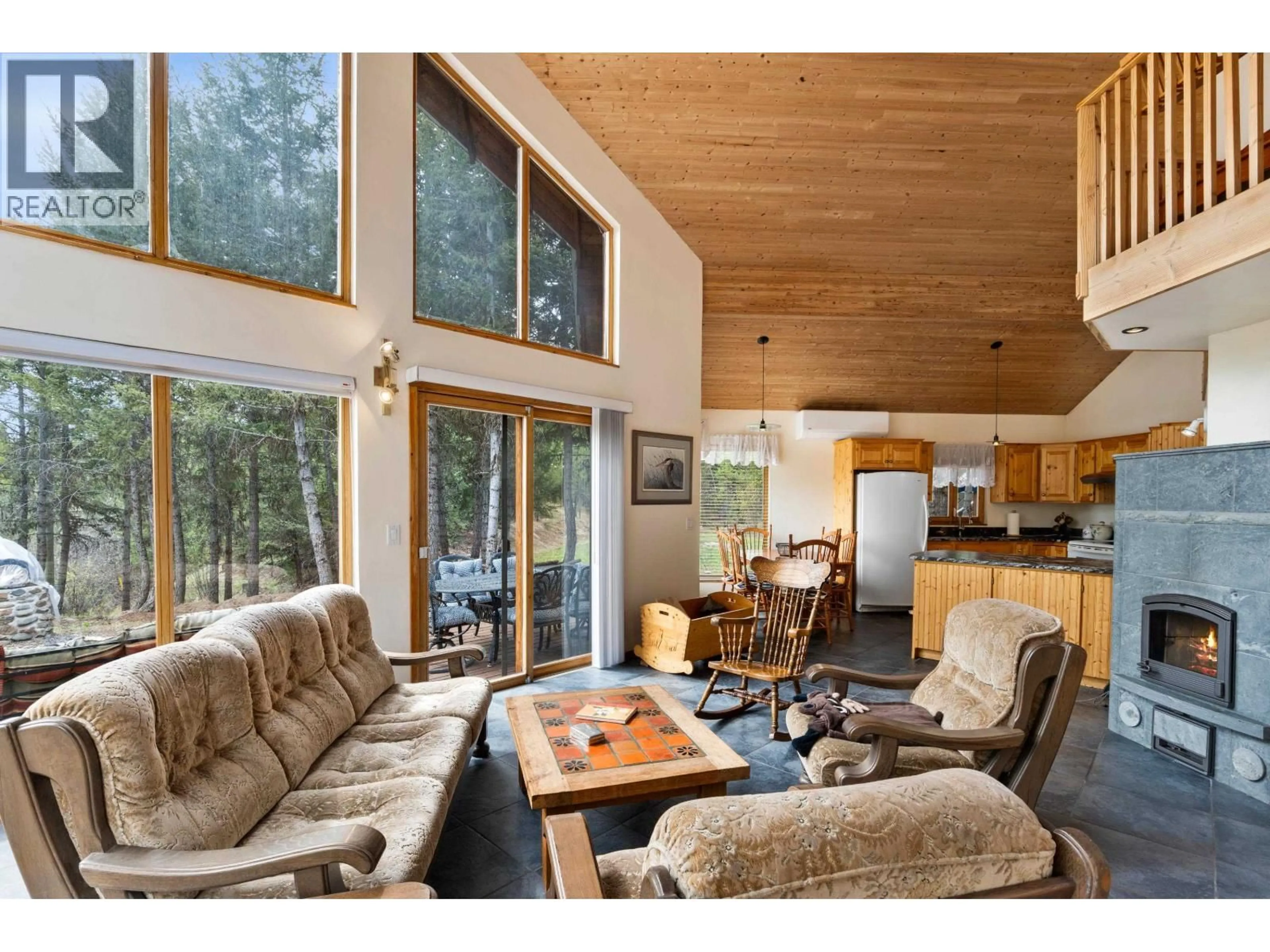 Living room with furniture, wood/laminate floor for 7815 BELL ROAD, Bridge Lake British Columbia V0K1X2