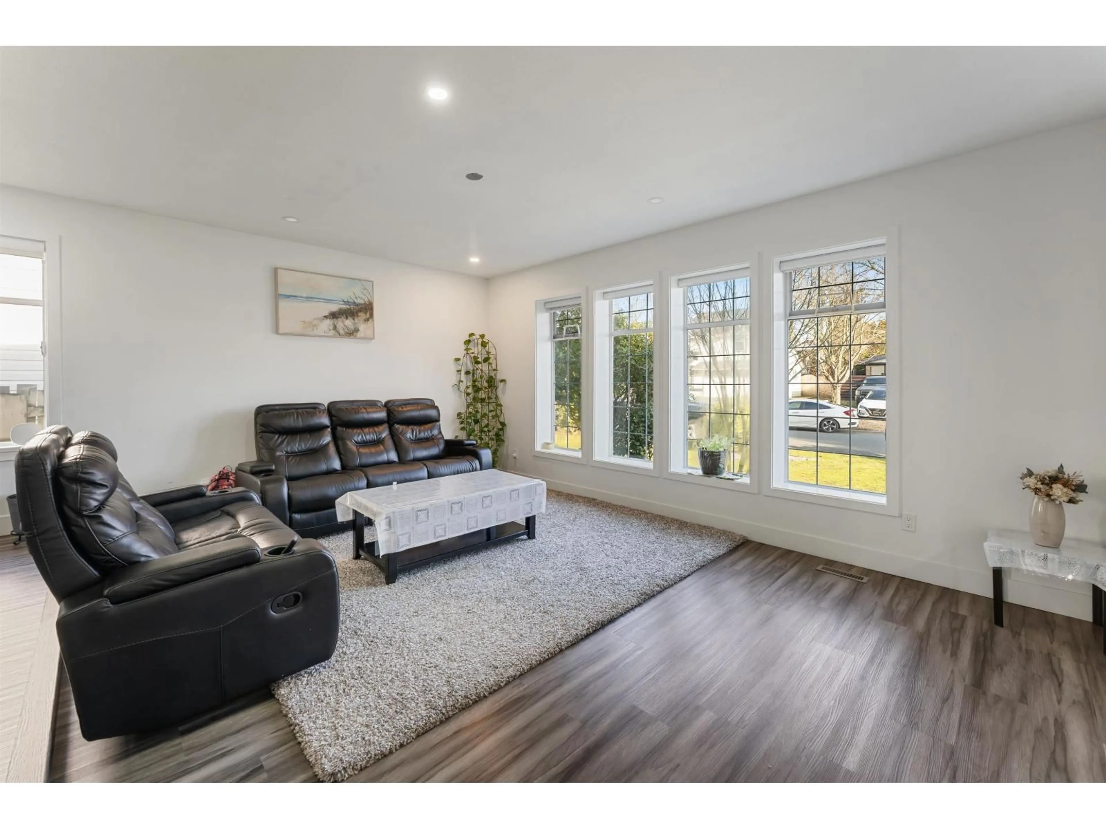 Living room with furniture, wood/laminate floor for 7309 123 STREET, Surrey British Columbia V3W9J2