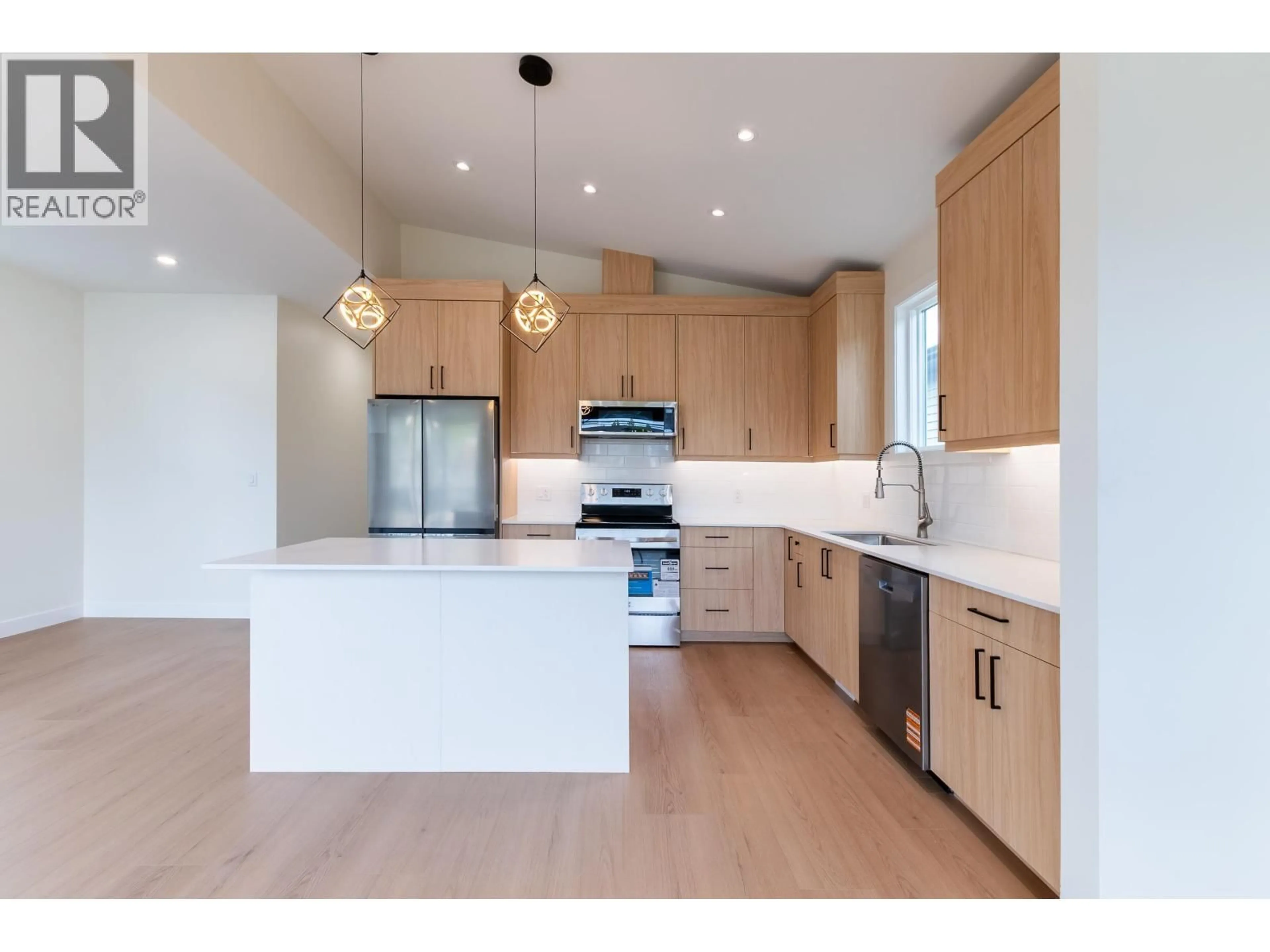 Open concept kitchen, wood/laminate floor for 1660 11TH AVENUE, Prince George British Columbia V2L3S8