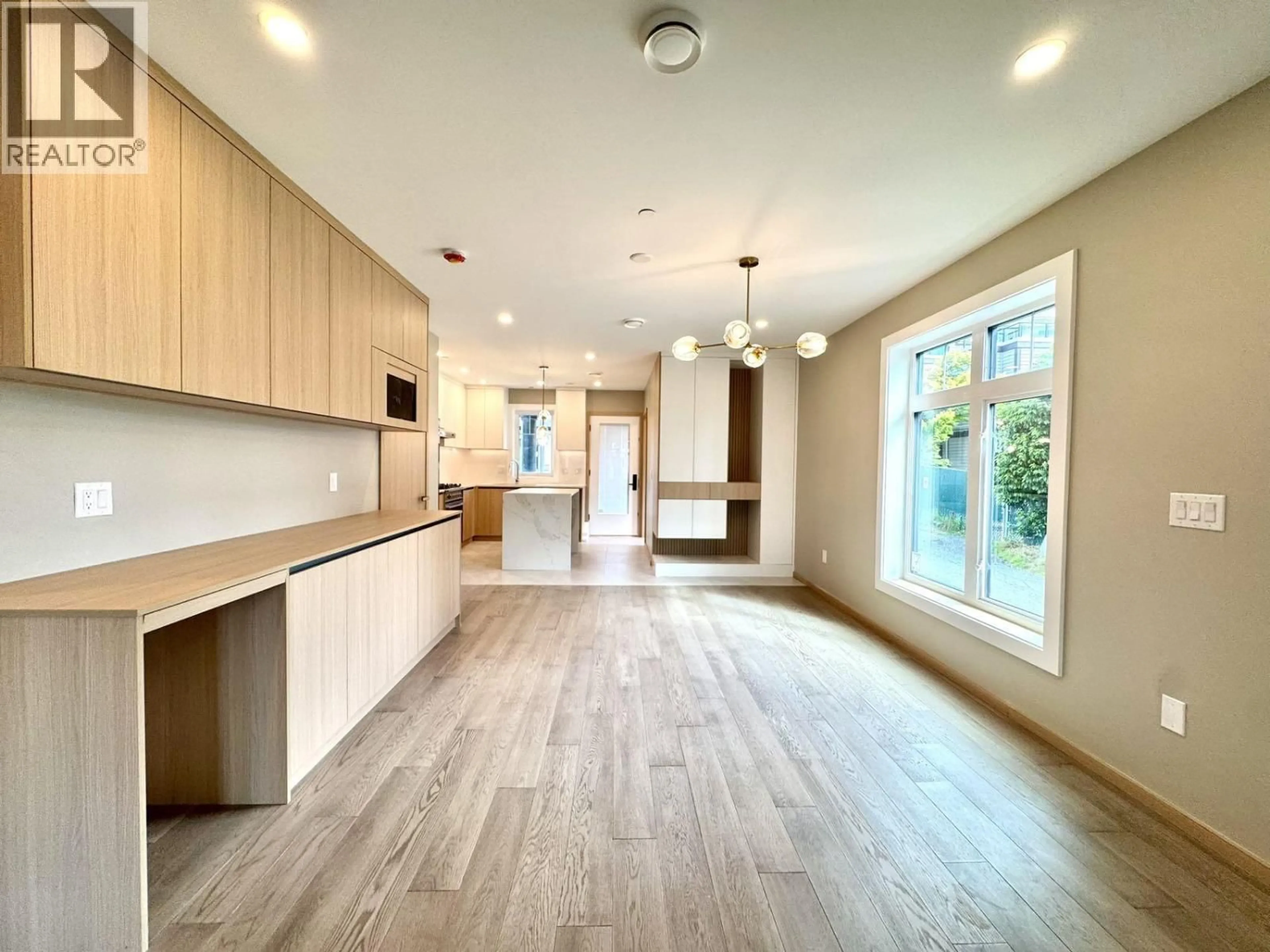 Open concept kitchen, wood/laminate floor for 5218 RUPERT STREET, Vancouver British Columbia V5R2J9