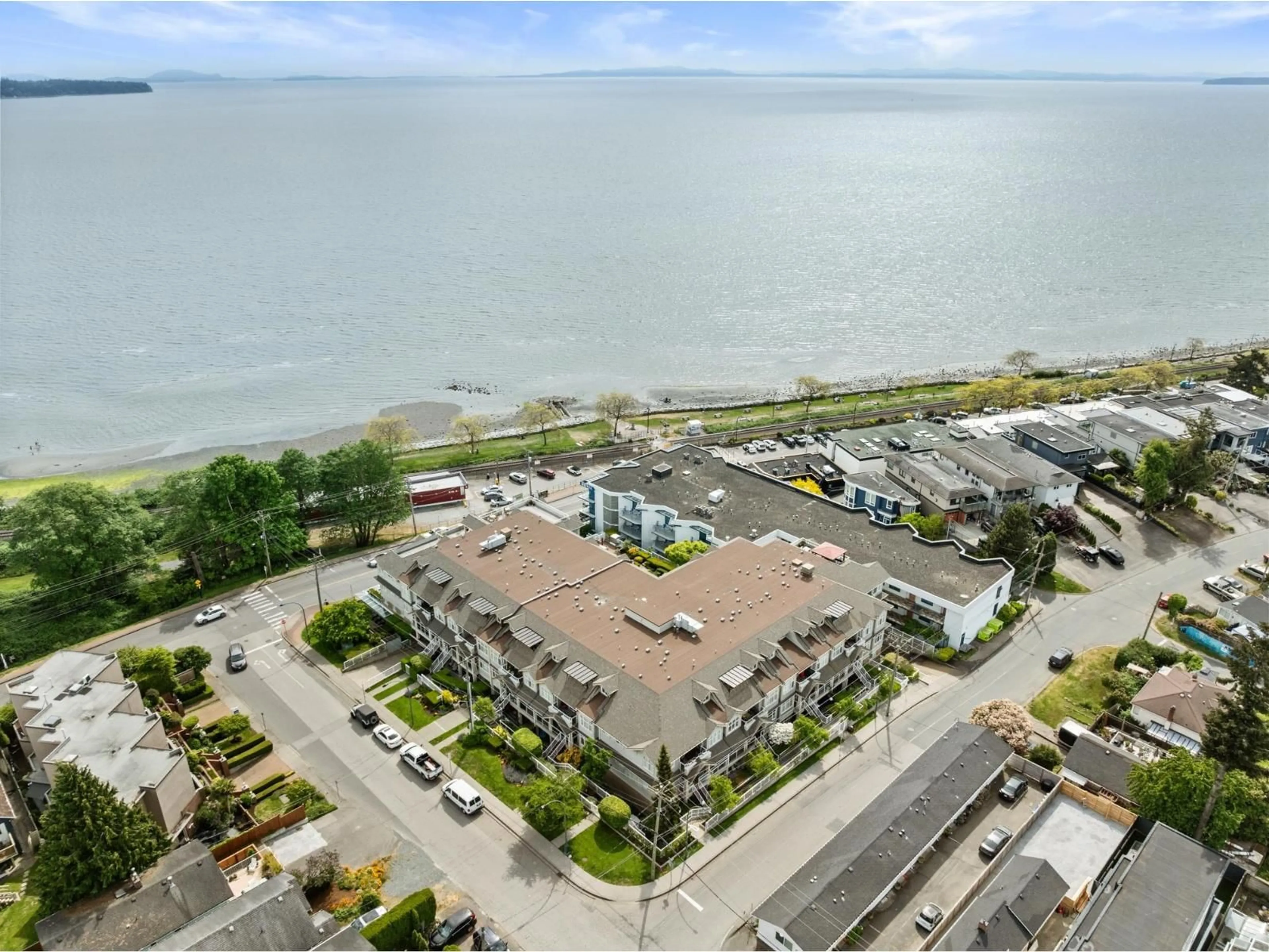 A pic from outside/outdoor area/front of a property/back of a property/a pic from drone, water/lake/river/ocean view for 212 - 15621 MARINE DRIVE, White Rock British Columbia V4B1E1