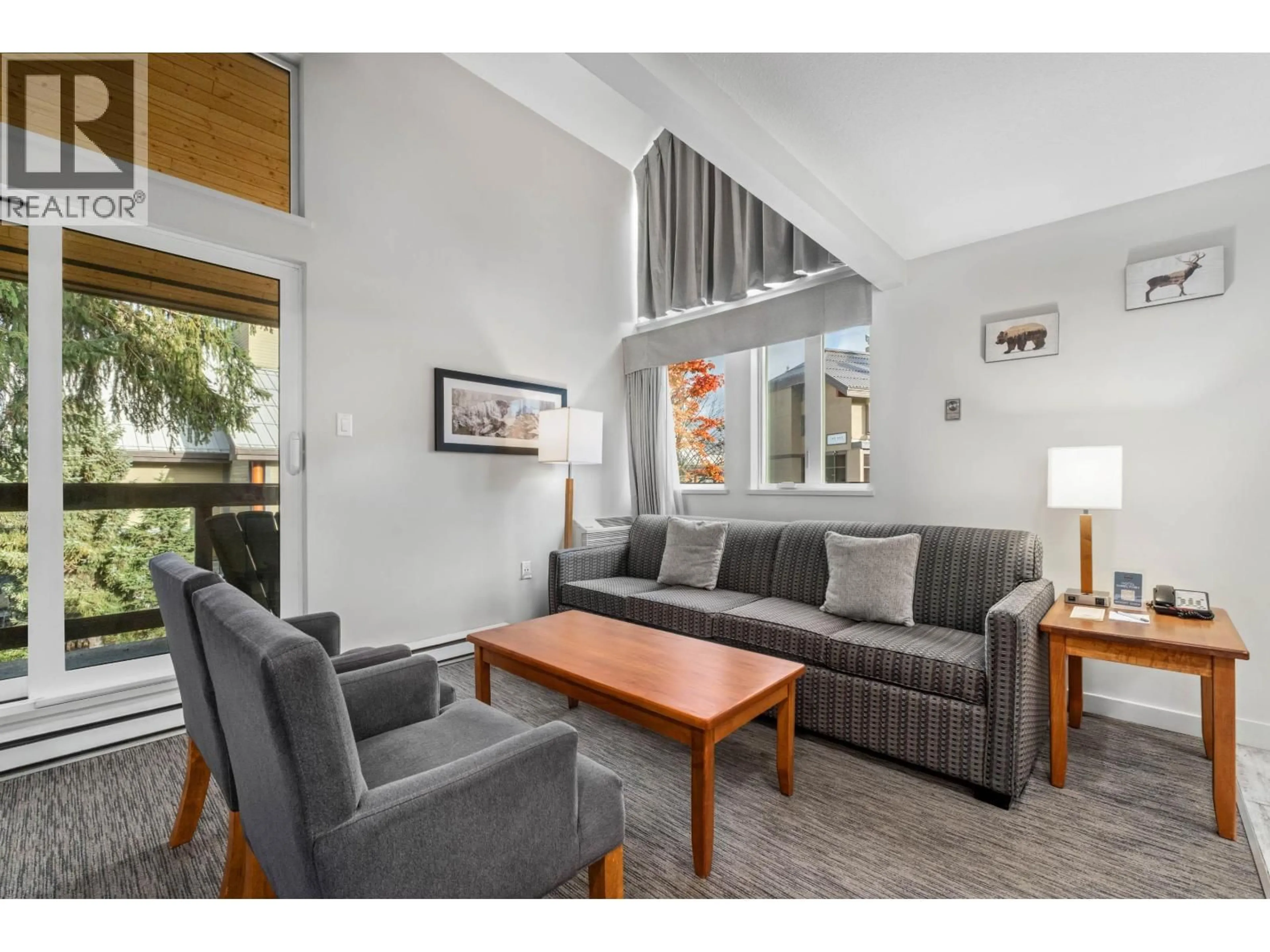 Living room with furniture, wood/laminate floor for 202 - 4420 SUNDIAL PLACE, Whistler British Columbia V8E1G6