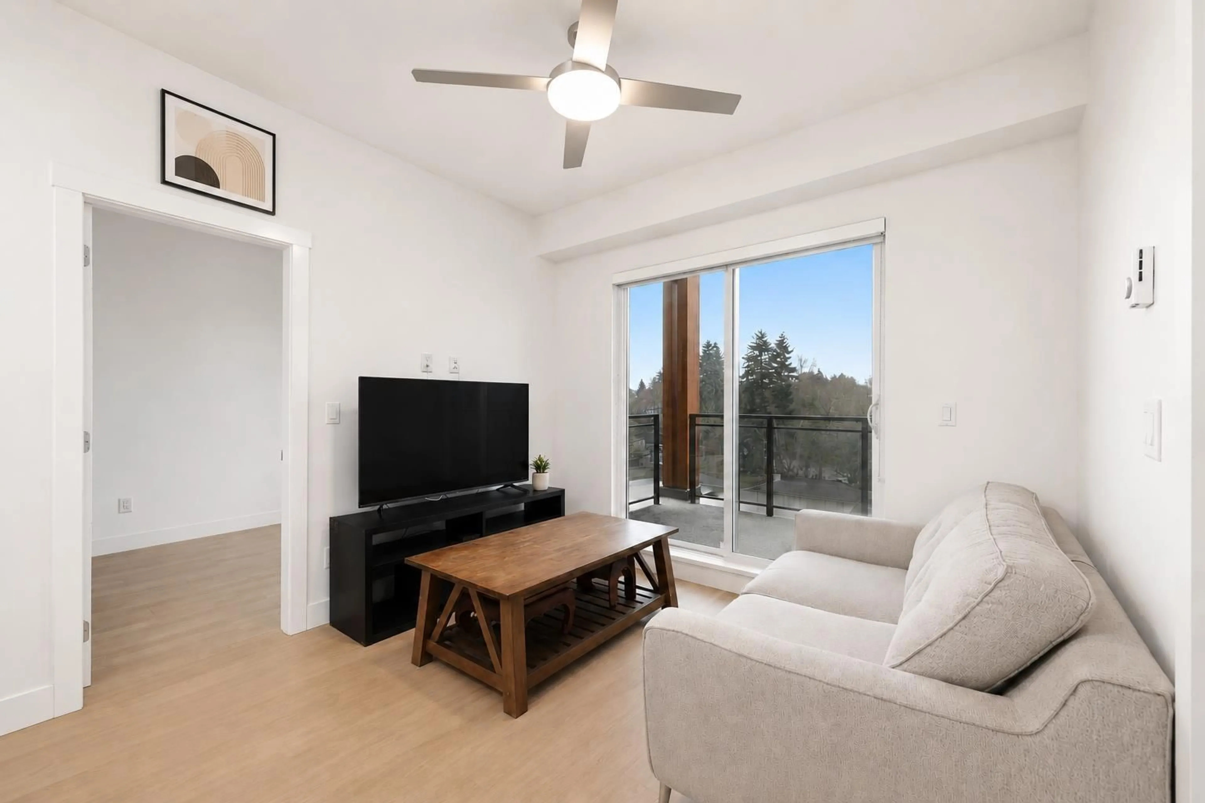 Living room with furniture, wood/laminate floor for 501 - 6950 NICHOLSON ROAD, Delta British Columbia V4E0A8