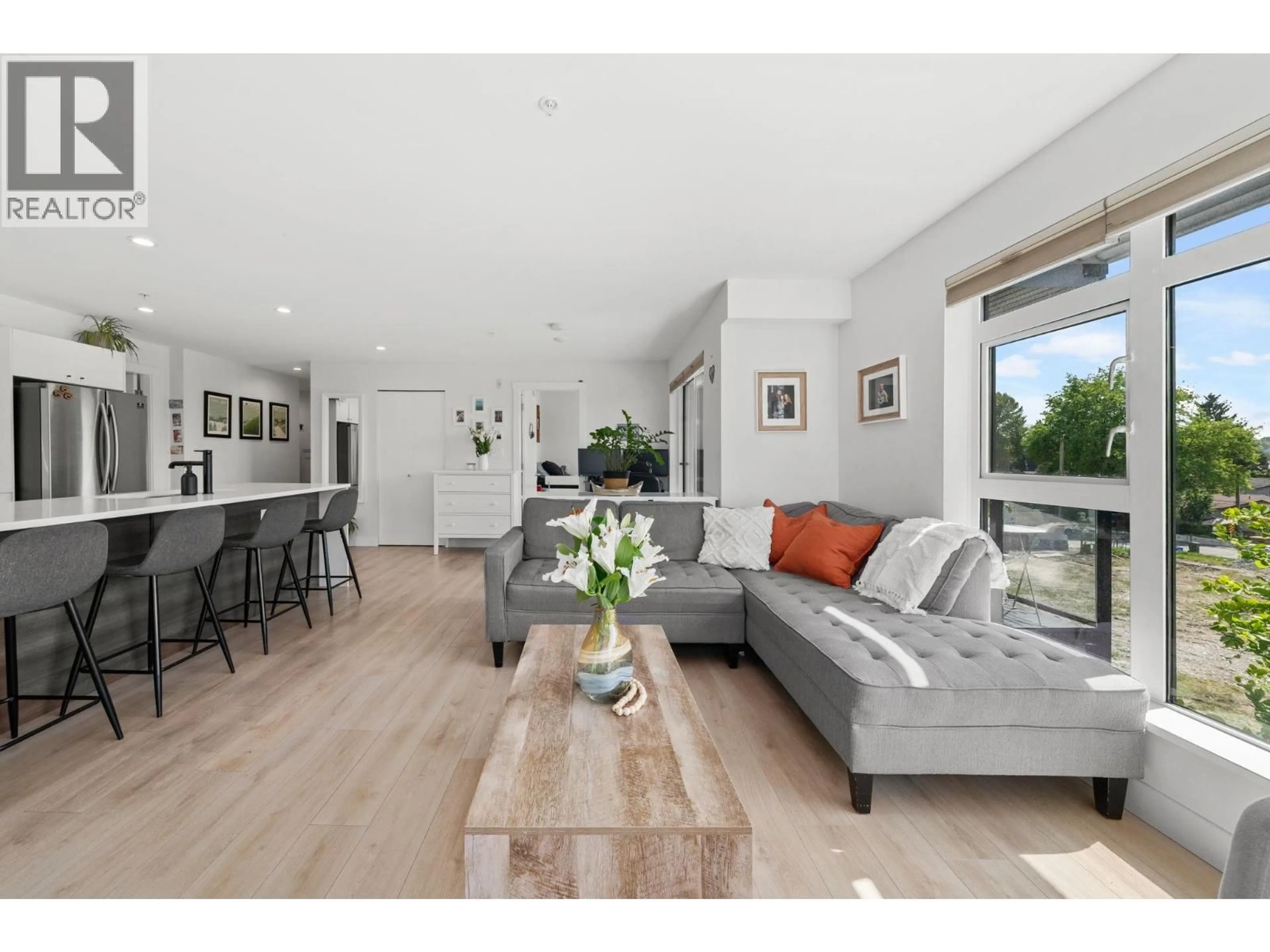 Living room with furniture, wood/laminate floor for 307 - 1519 CROWN STREET, North Vancouver British Columbia V7J1G6