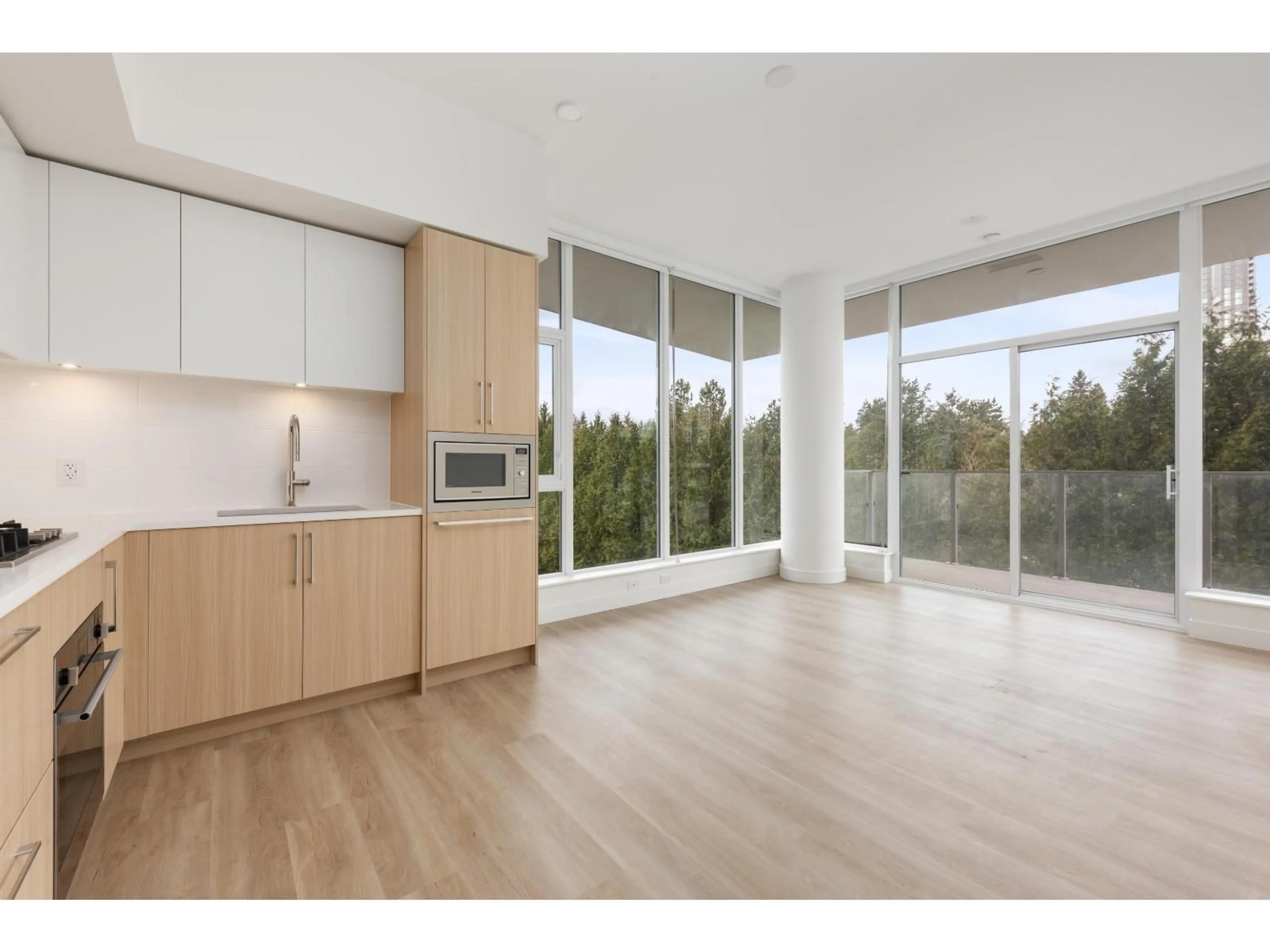Open concept kitchen, wood/laminate floor for 416 - 9675 KING GEORGE BOULEVARD, Surrey British Columbia V3T0T7