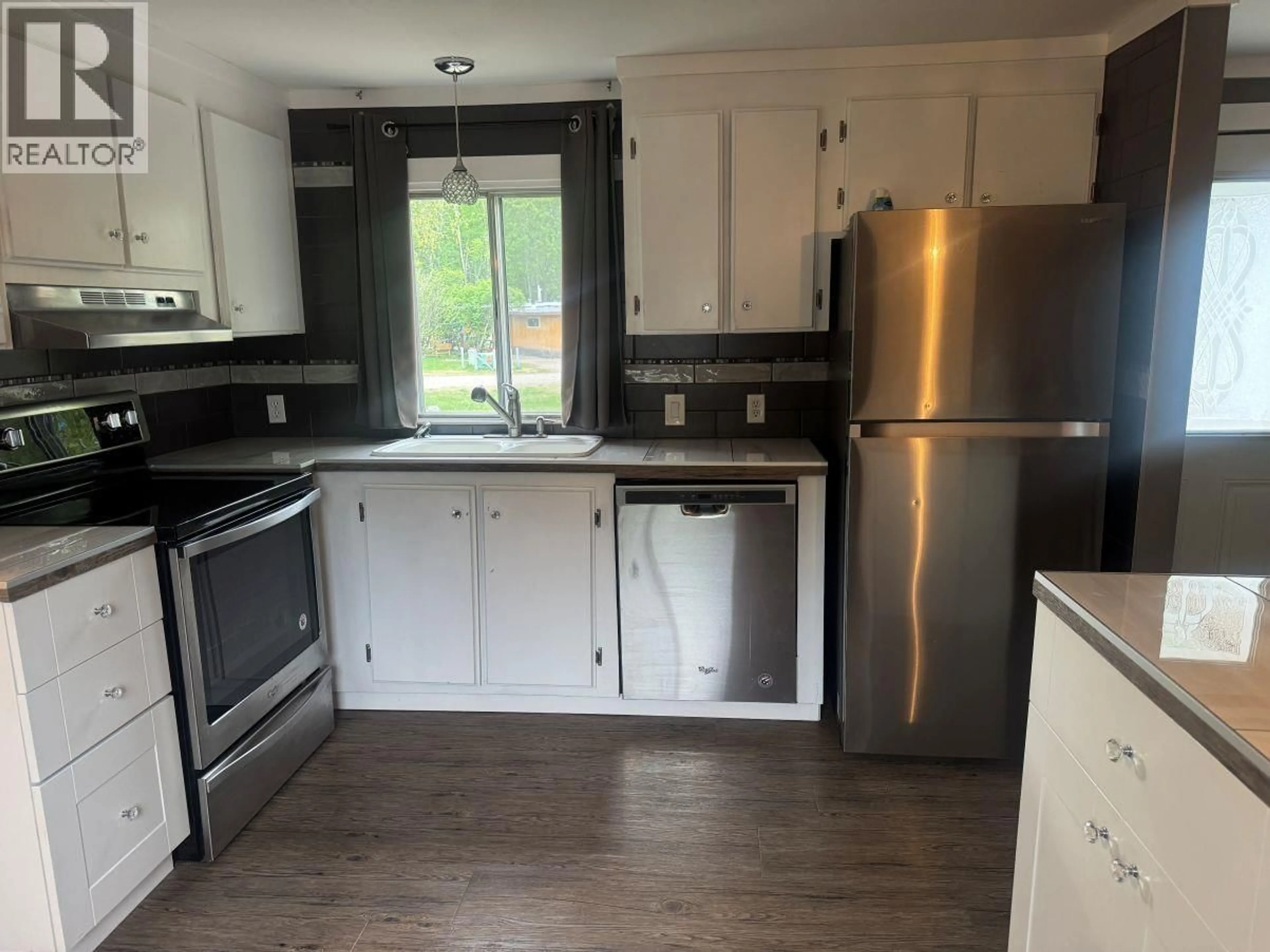 Open concept kitchen, wood/laminate floor for 30 - 6100 DAKELH, Prince George British Columbia V2N4R1