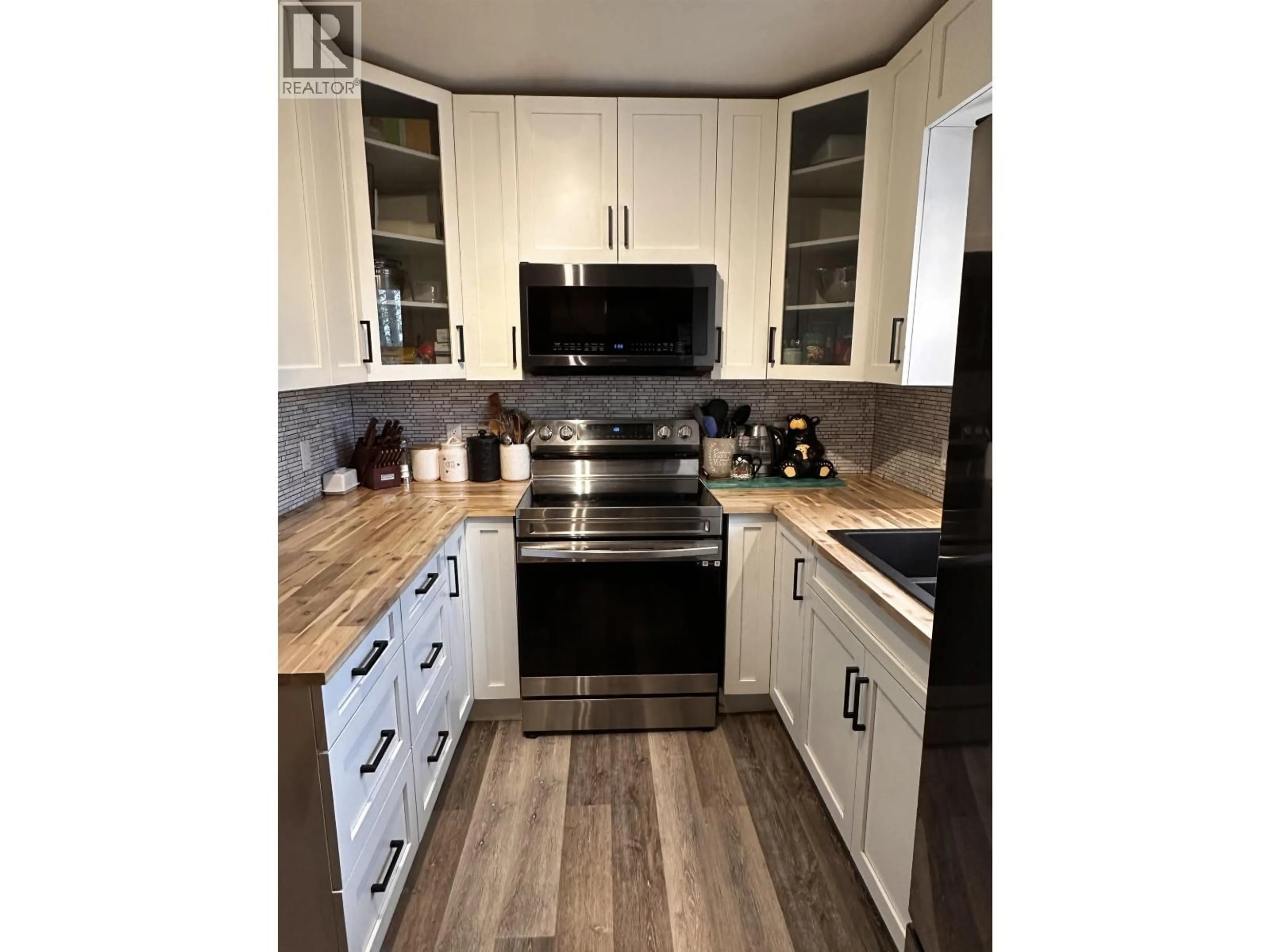 Open concept kitchen, wood/laminate floor for 5620 49 STREET, Fort Nelson British Columbia V0C1R0