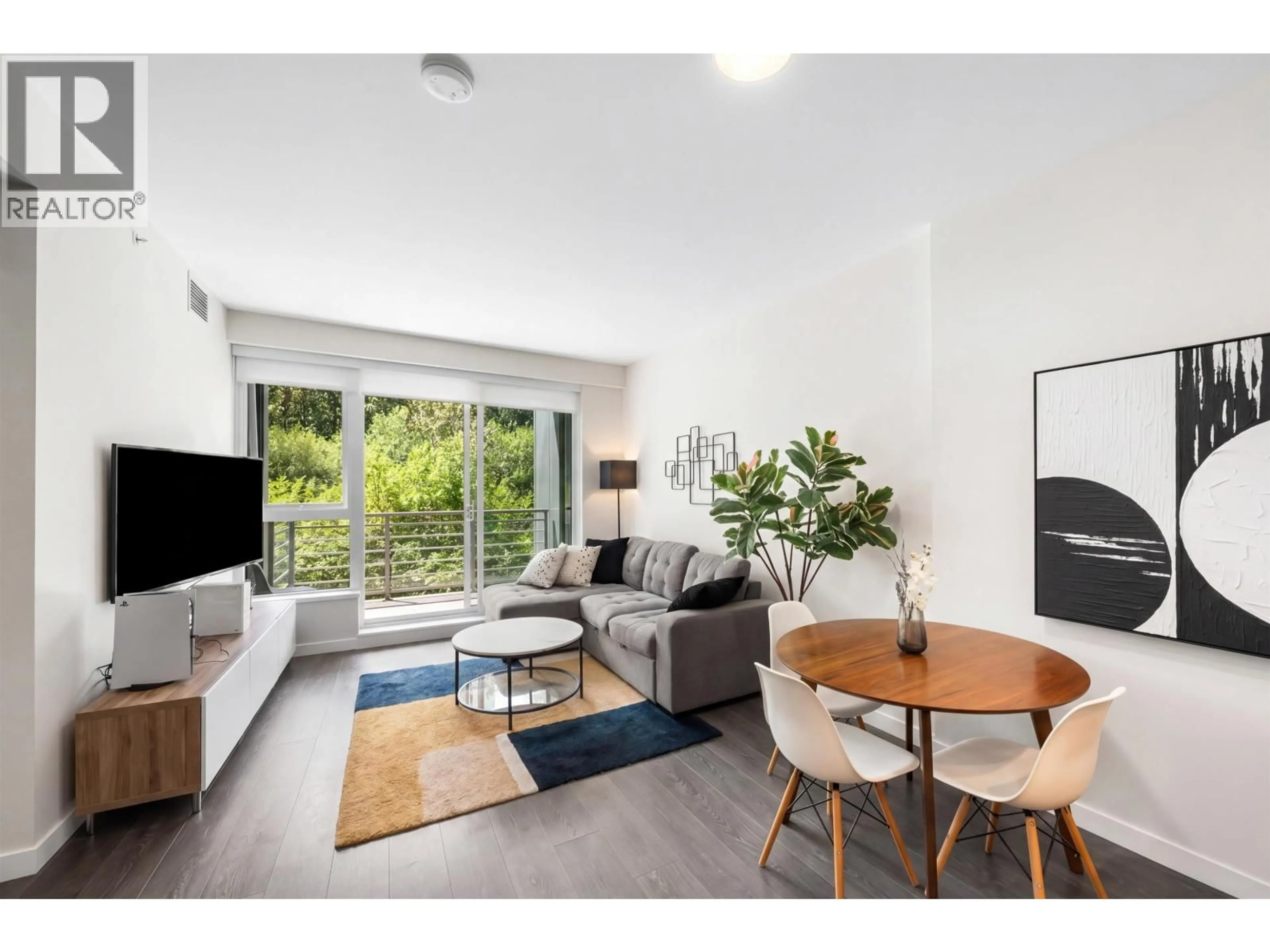 Living room with furniture, wood/laminate floor for 405 - 308 MORRISSEY ROAD, Port Moody British Columbia V3H0M2