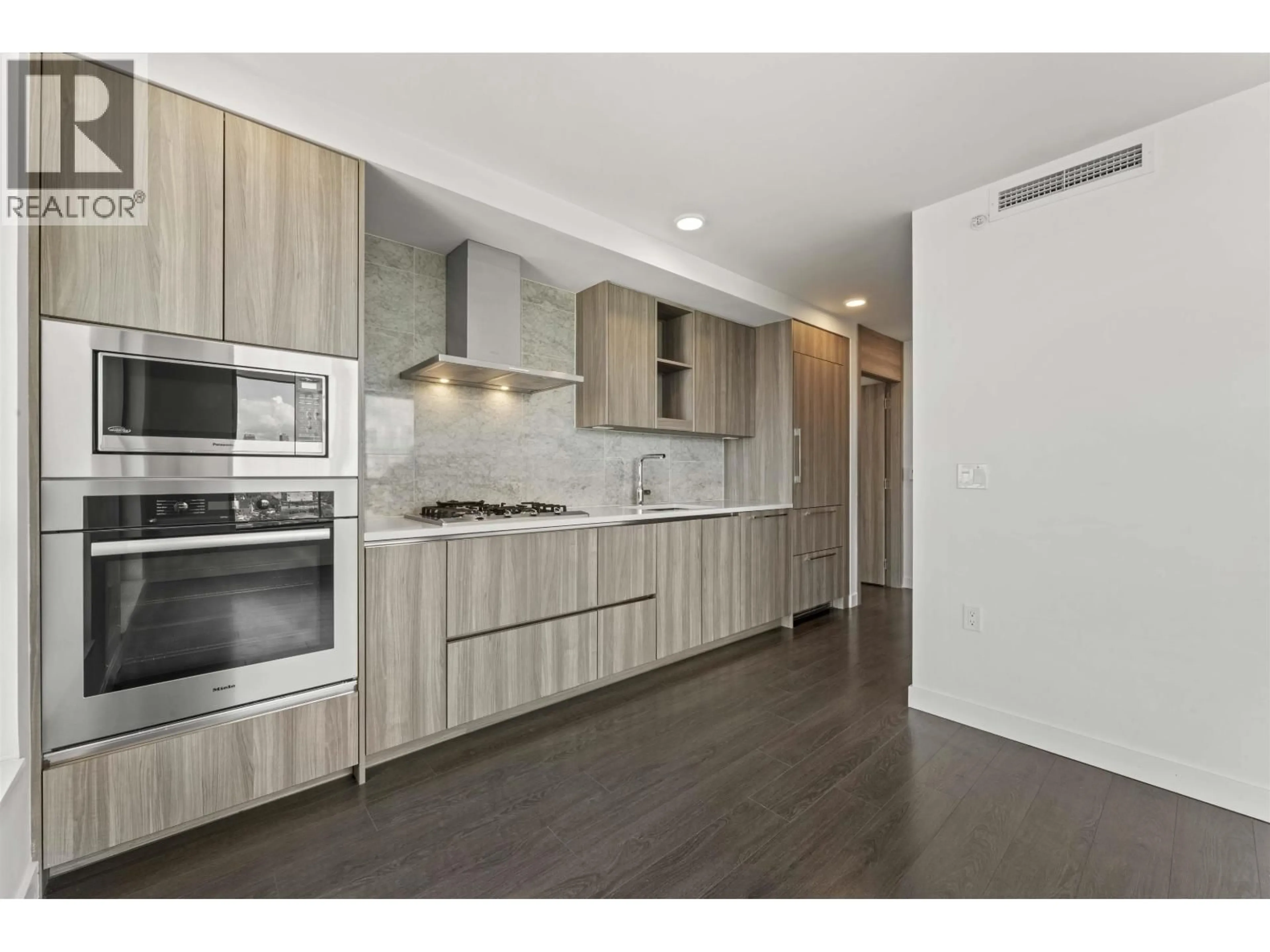 Open concept kitchen, wood/laminate floor for 2709 - 455 MARINE DRIVE, Vancouver British Columbia V5X0H3