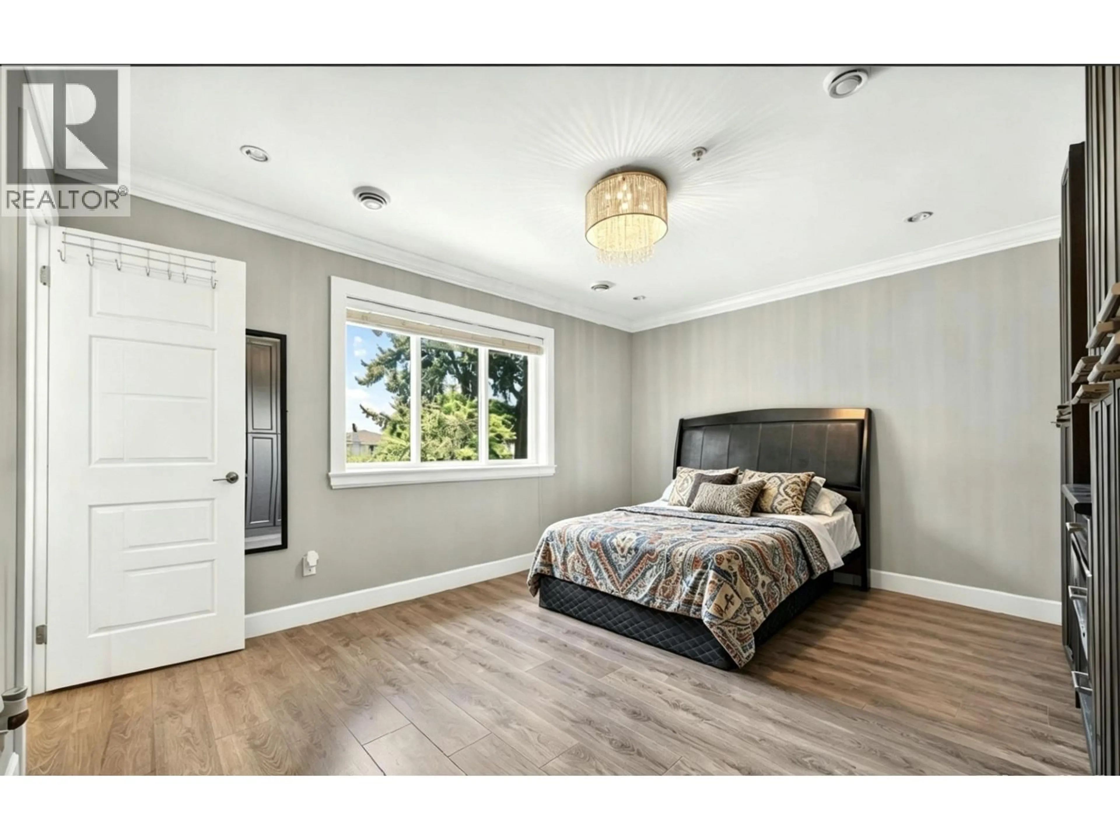Bedroom with bed, wood/laminate floor for 3034 KINGS AVENUE, Vancouver British Columbia V5R4T2