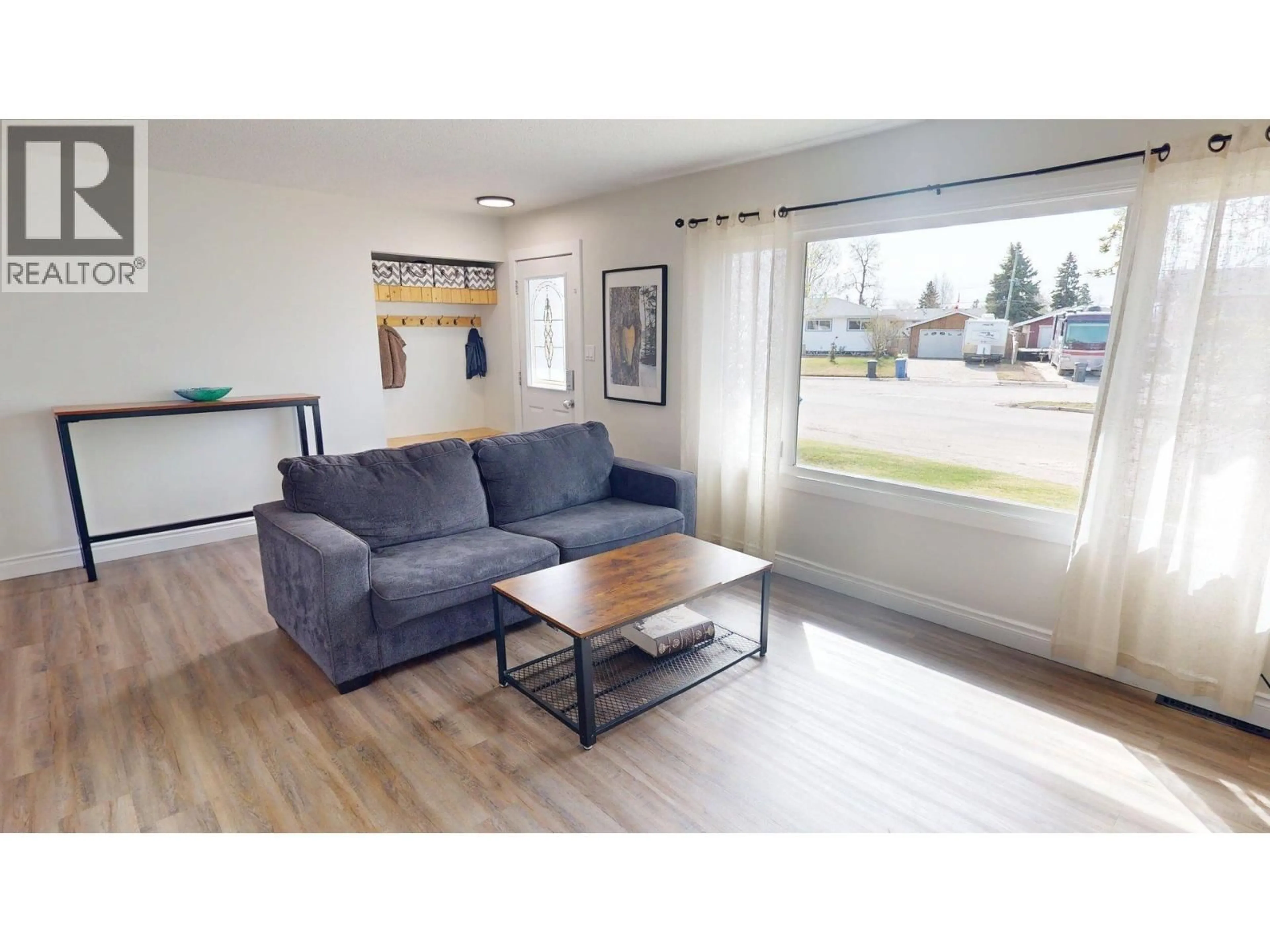 Living room with furniture, wood/laminate floor for 9524 111 AVENUE, Fort St. John British Columbia V1J2T8