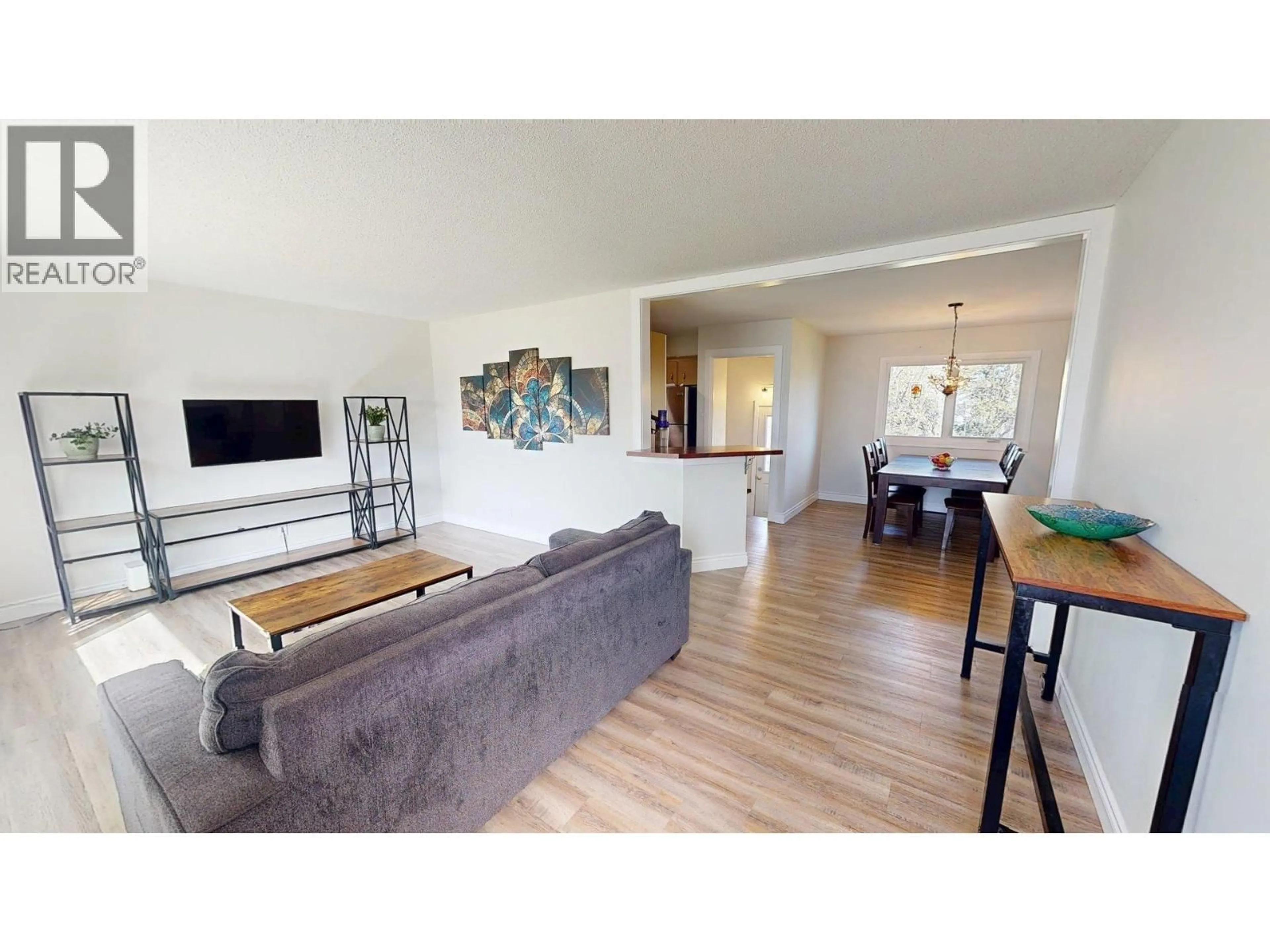 Living room with furniture, wood/laminate floor for 9524 111 AVENUE, Fort St. John British Columbia V1J2T8