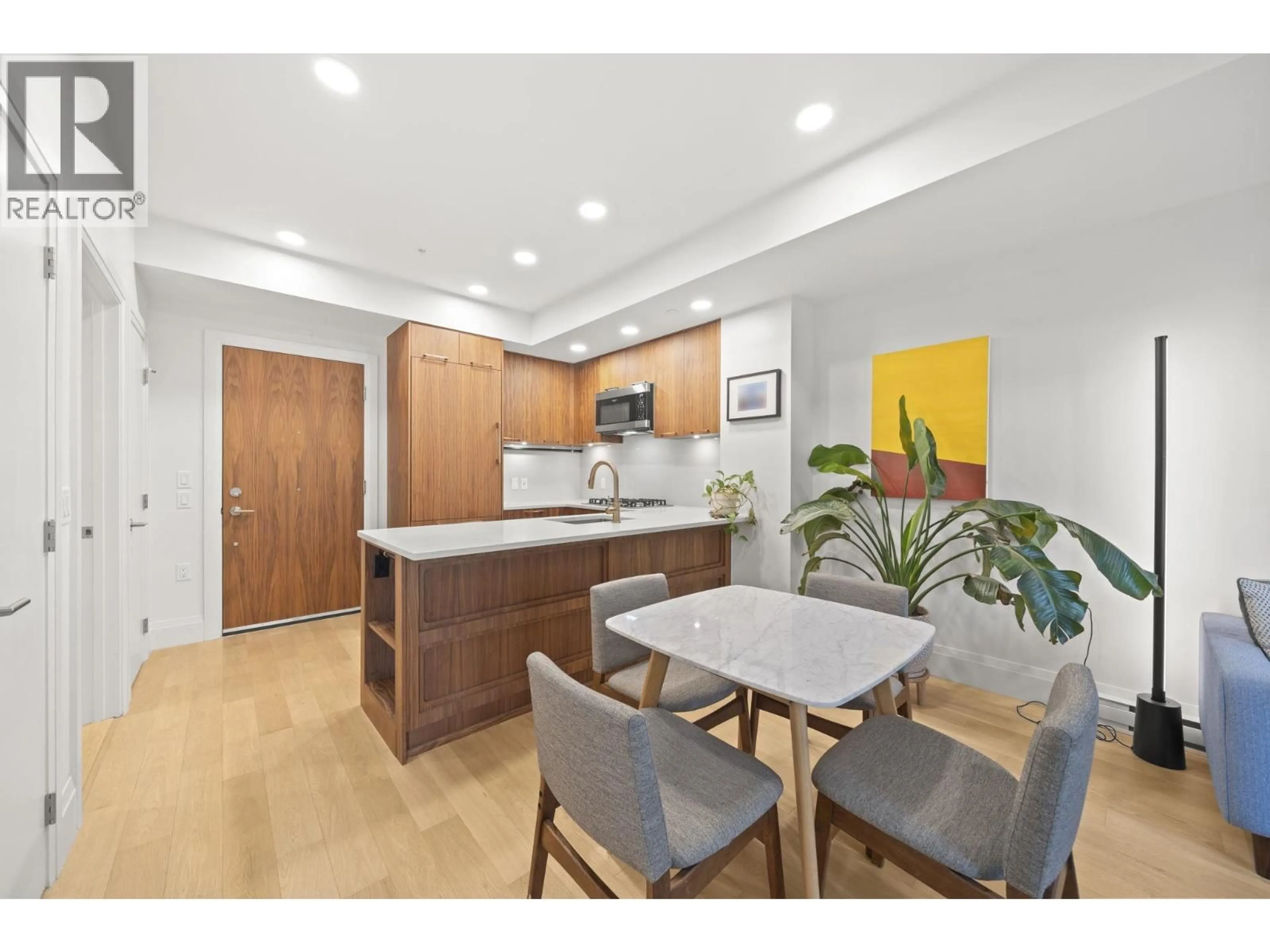 Open concept kitchen, wood/laminate floor for 205 - 2550 GARDEN DRIVE, Vancouver British Columbia V5N4X6