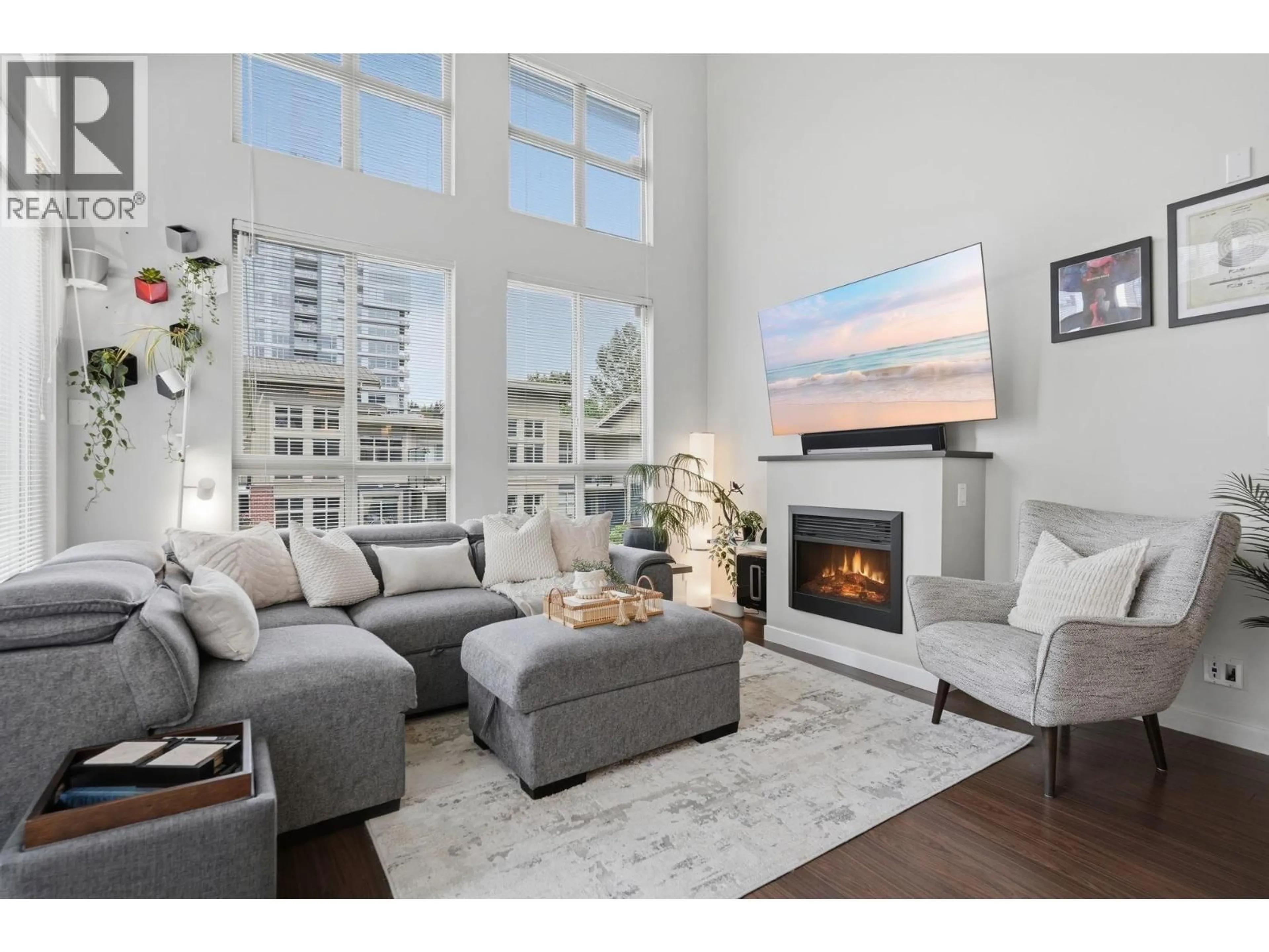 Living room with furniture, wood/laminate floor for 421 - 101 MORRISSEY ROAD, Port Moody British Columbia V3H0E6