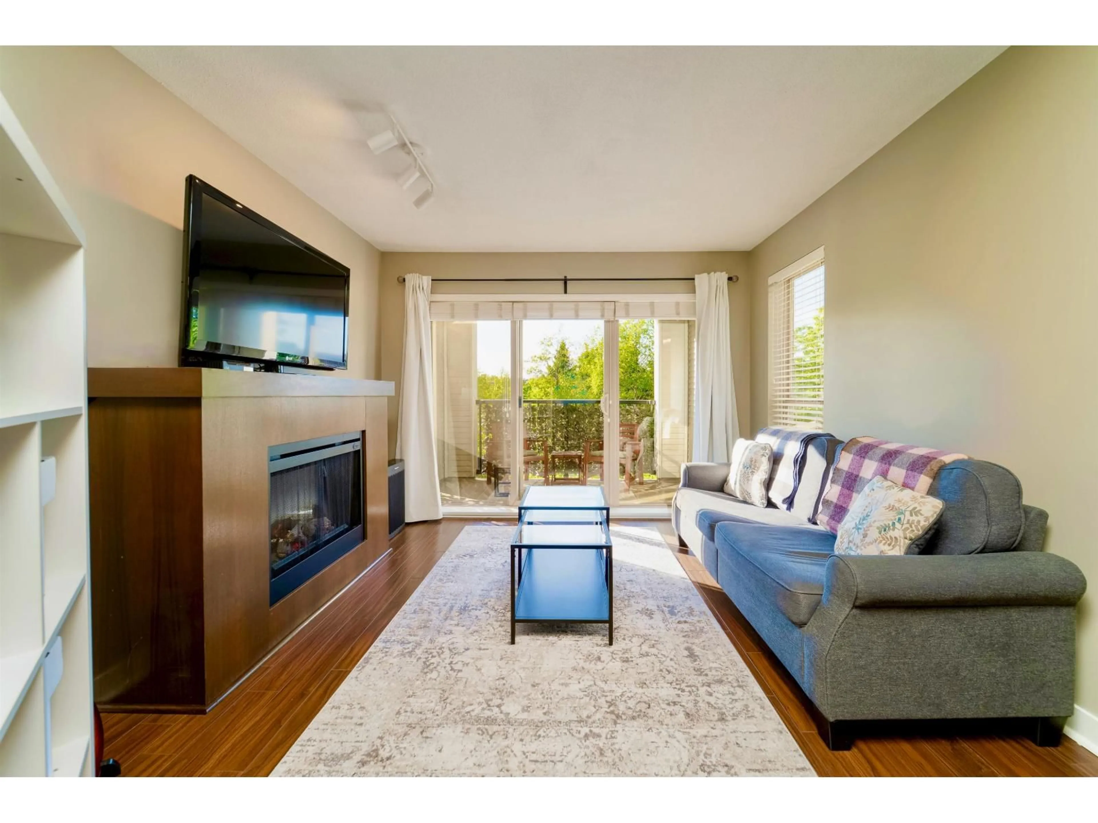 Living room with furniture, wood/laminate floor for D207 - 8929 202 STREET, Langley British Columbia V1M0B4