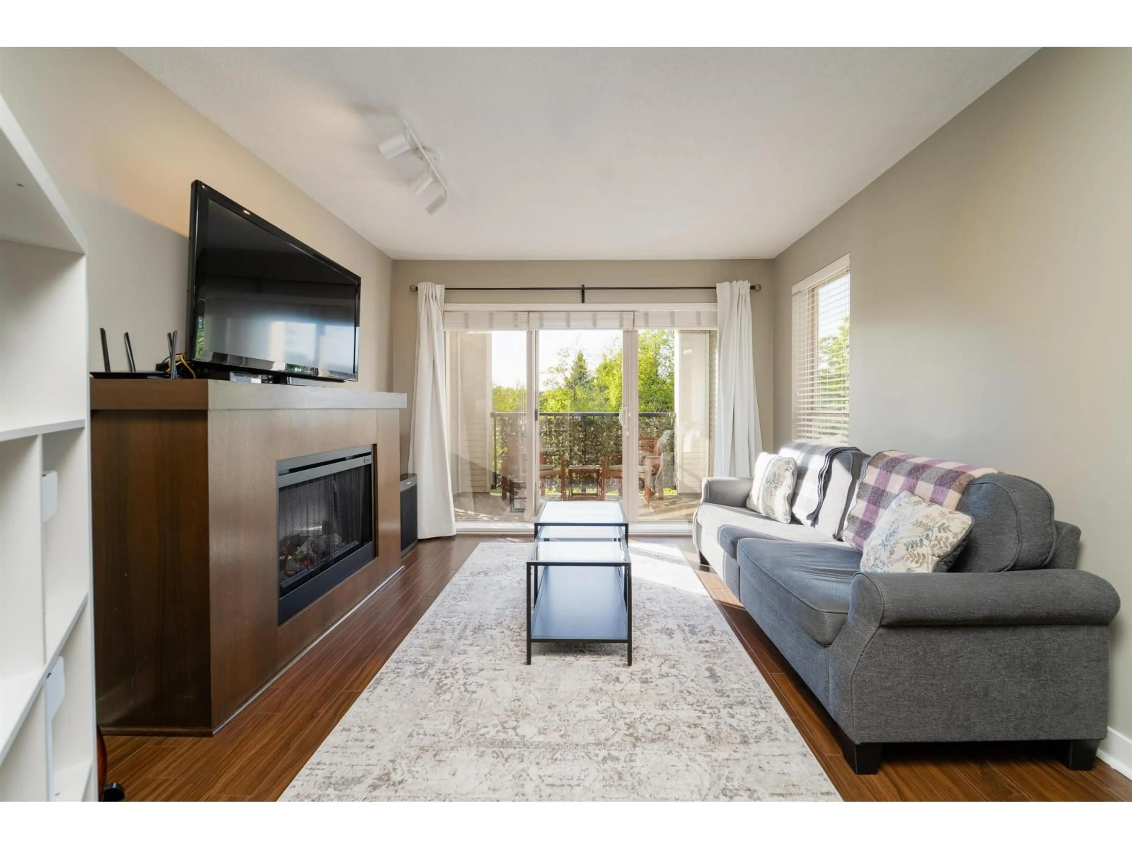 Living room with furniture, wood/laminate floor for D207 - 8929 202 STREET, Langley British Columbia V1M0B4