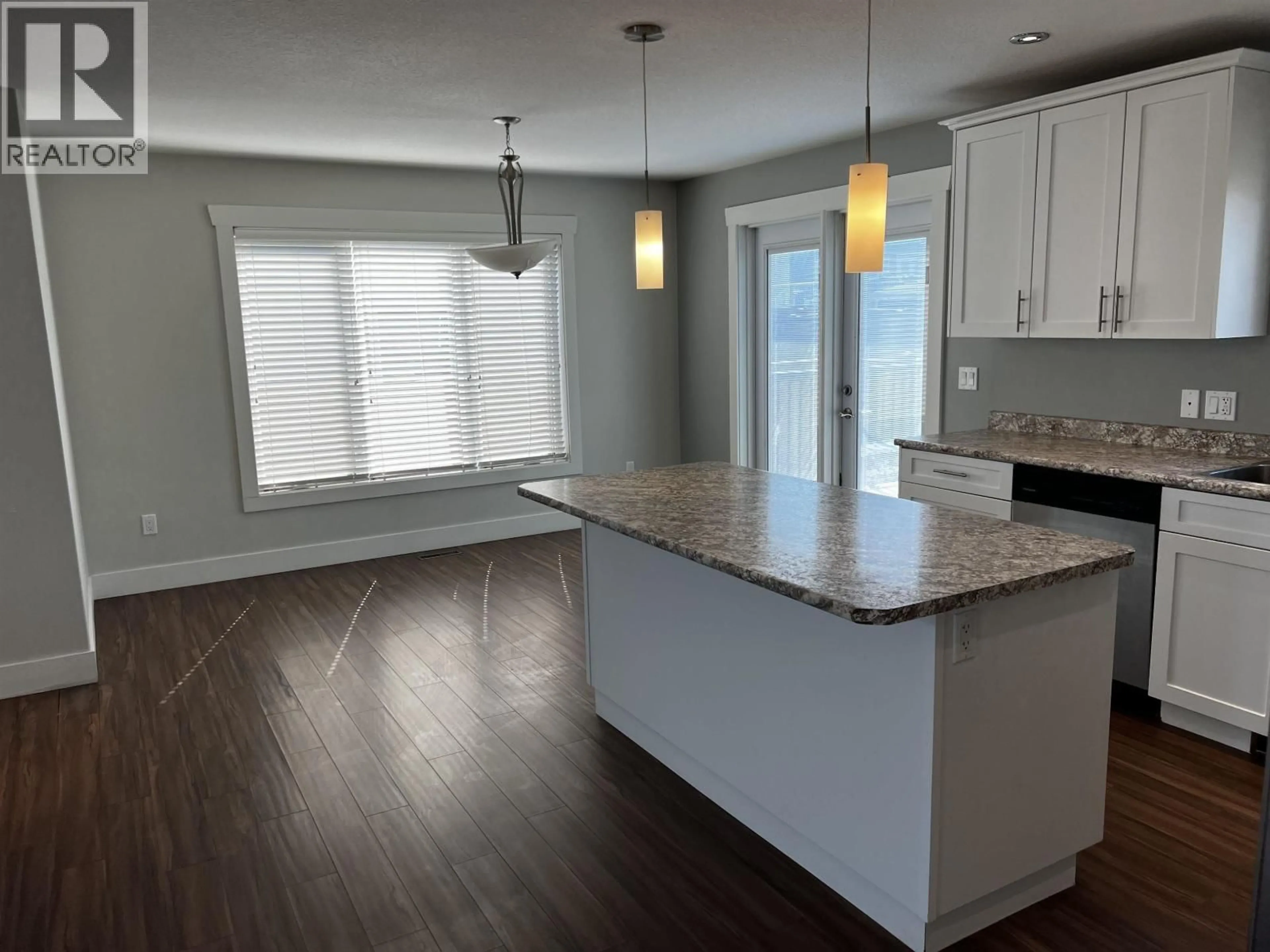 Open concept kitchen, wood/laminate floor for 10923 105 AVENUE, Fort St. John British Columbia V1J0L2