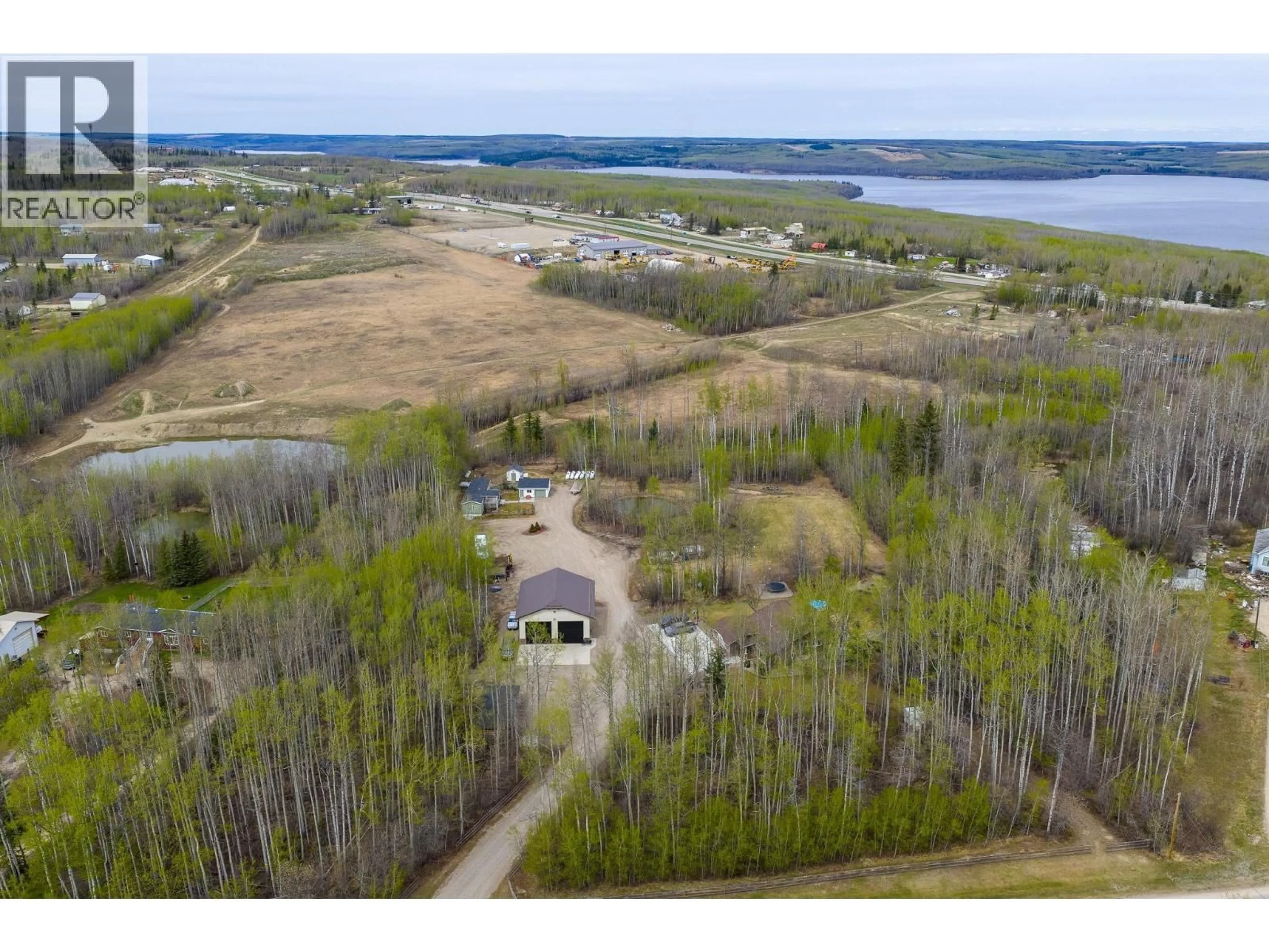 A pic from outside/outdoor area/front of a property/back of a property/a pic from drone, water/lake/river/ocean view for 13066 WRIGHT ROAD, Charlie Lake British Columbia V0C1H0