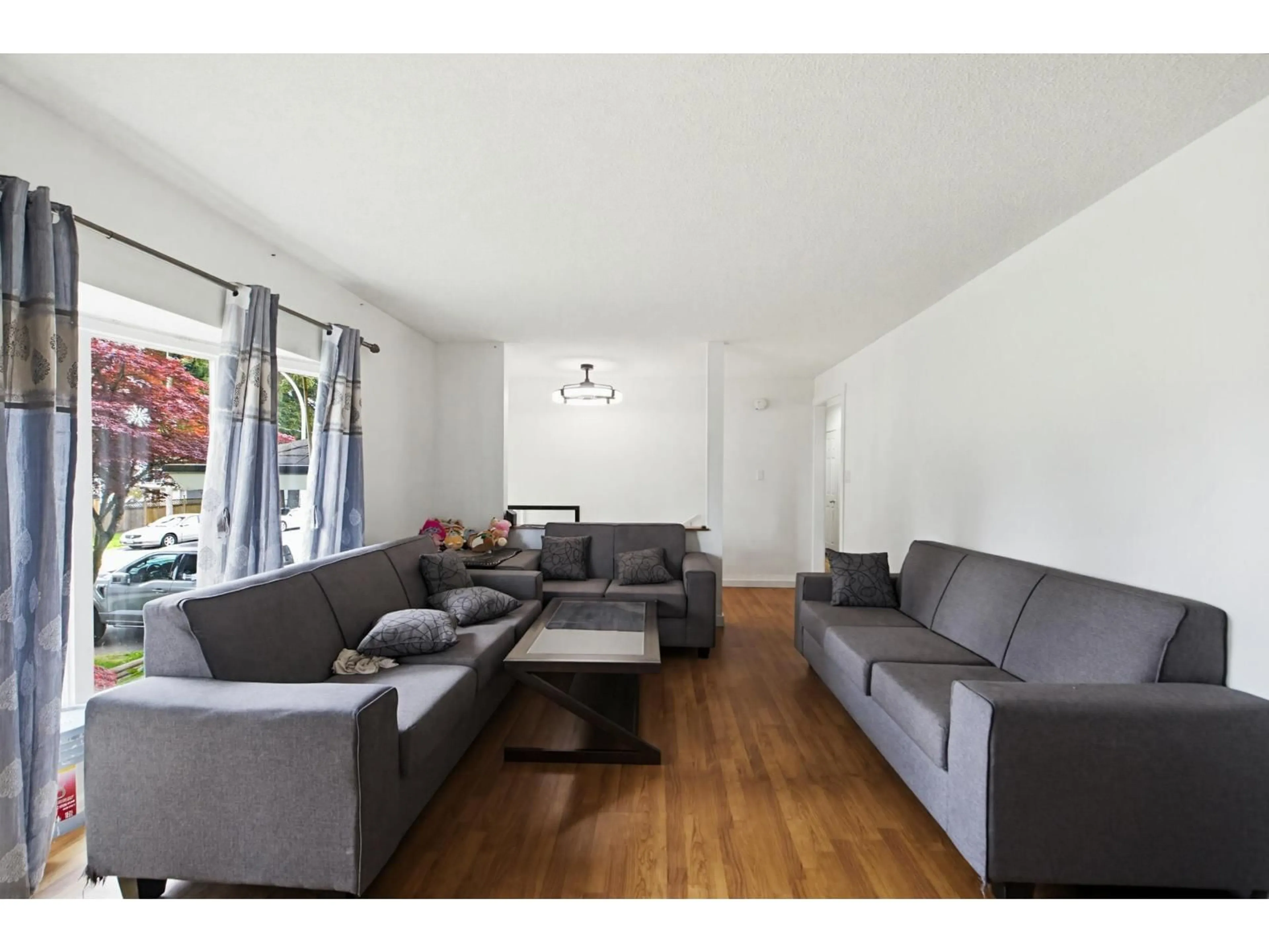Living room with furniture, wood/laminate floor for 8174 117 STREET, Delta British Columbia V4C7A6