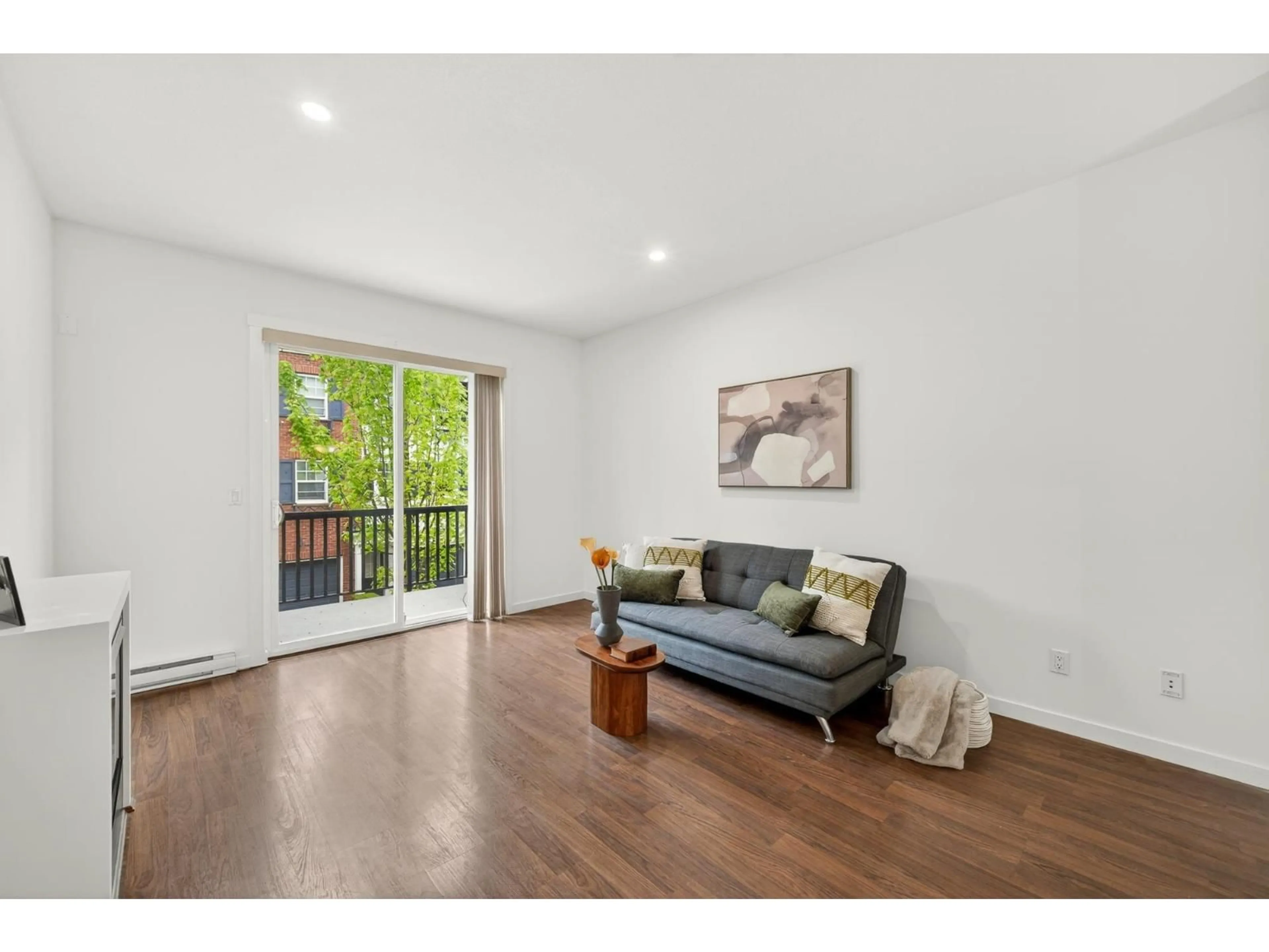 Living room with furniture, wood/laminate floor for 4 - 7348 192A STREET, Surrey British Columbia V4N6J2
