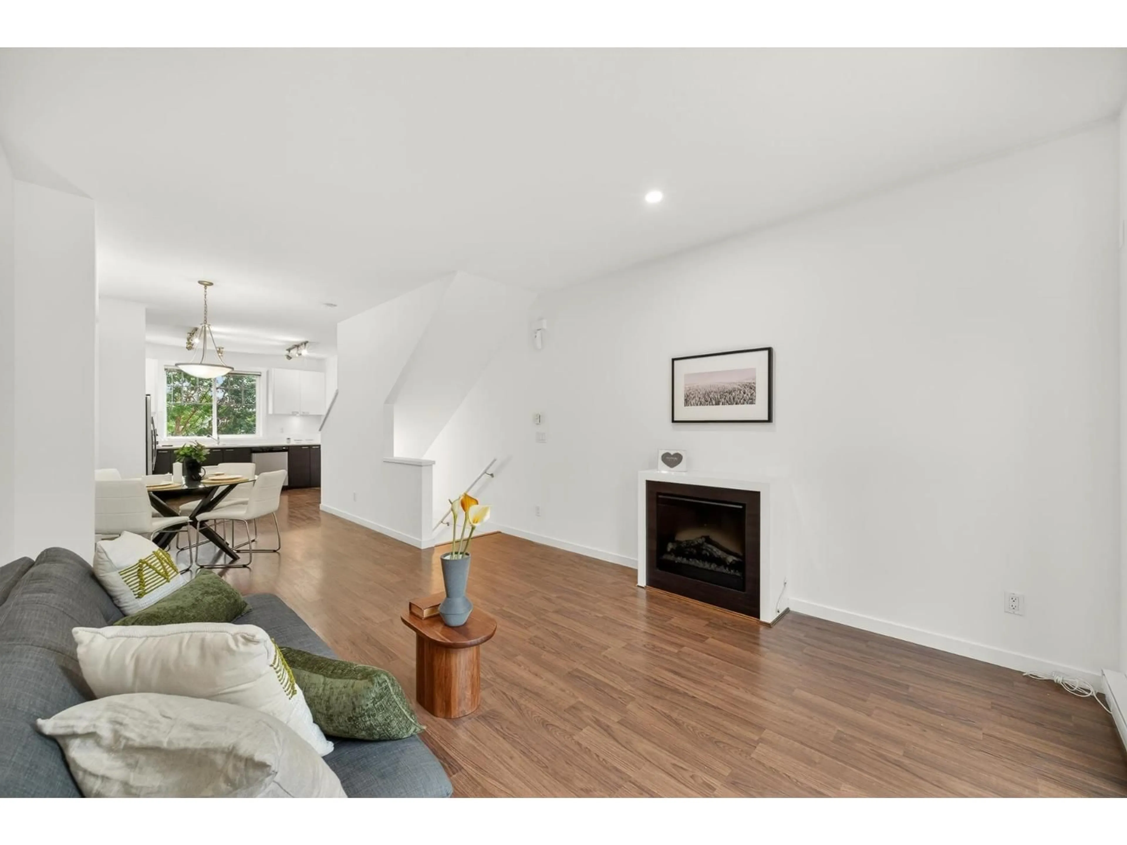 Living room with furniture, wood/laminate floor for 4 - 7348 192A STREET, Surrey British Columbia V4N6J2
