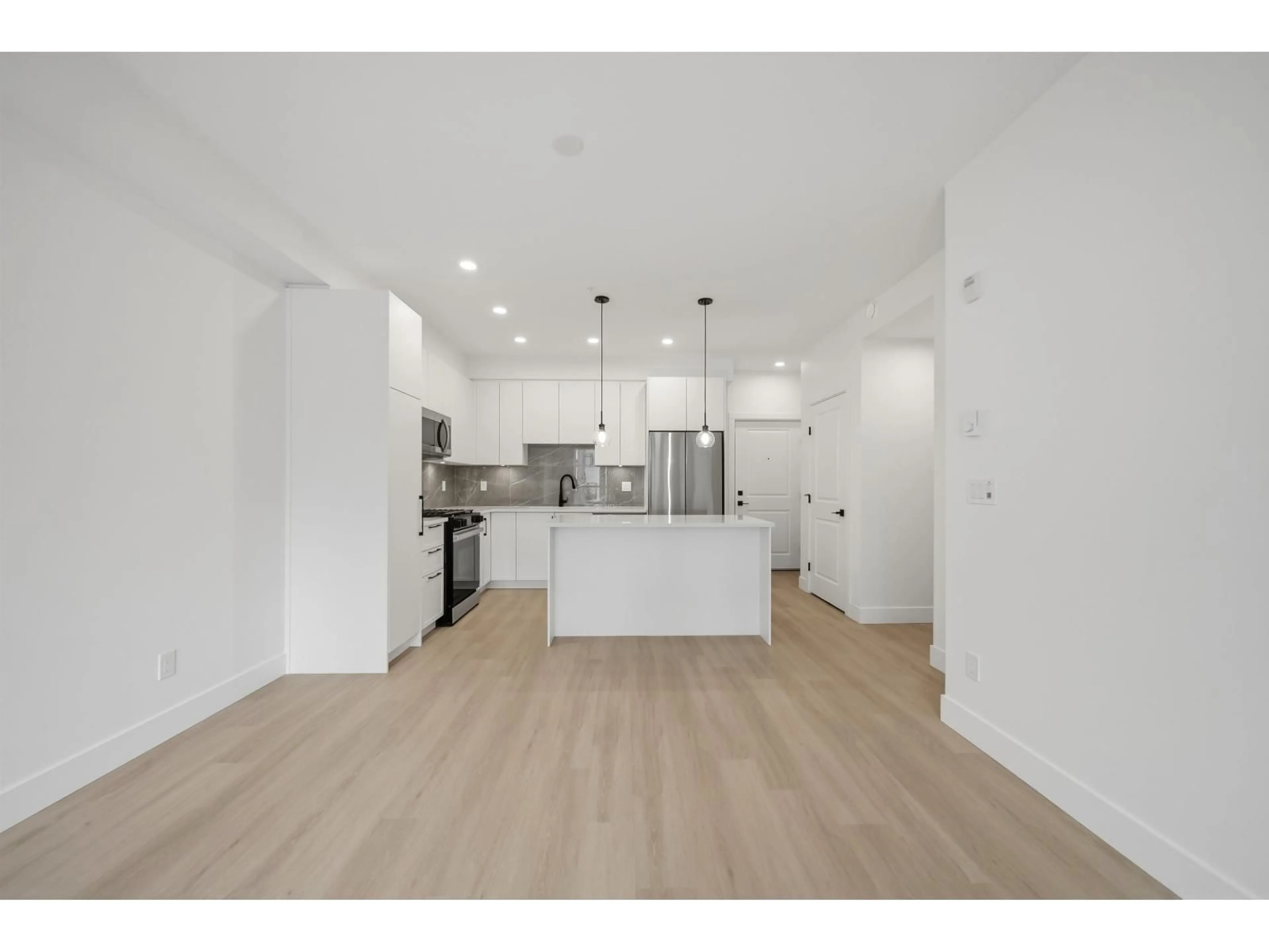Open concept kitchen, wood/laminate floor for 401 - 3438 146A STREET, Surrey British Columbia V0V0V0