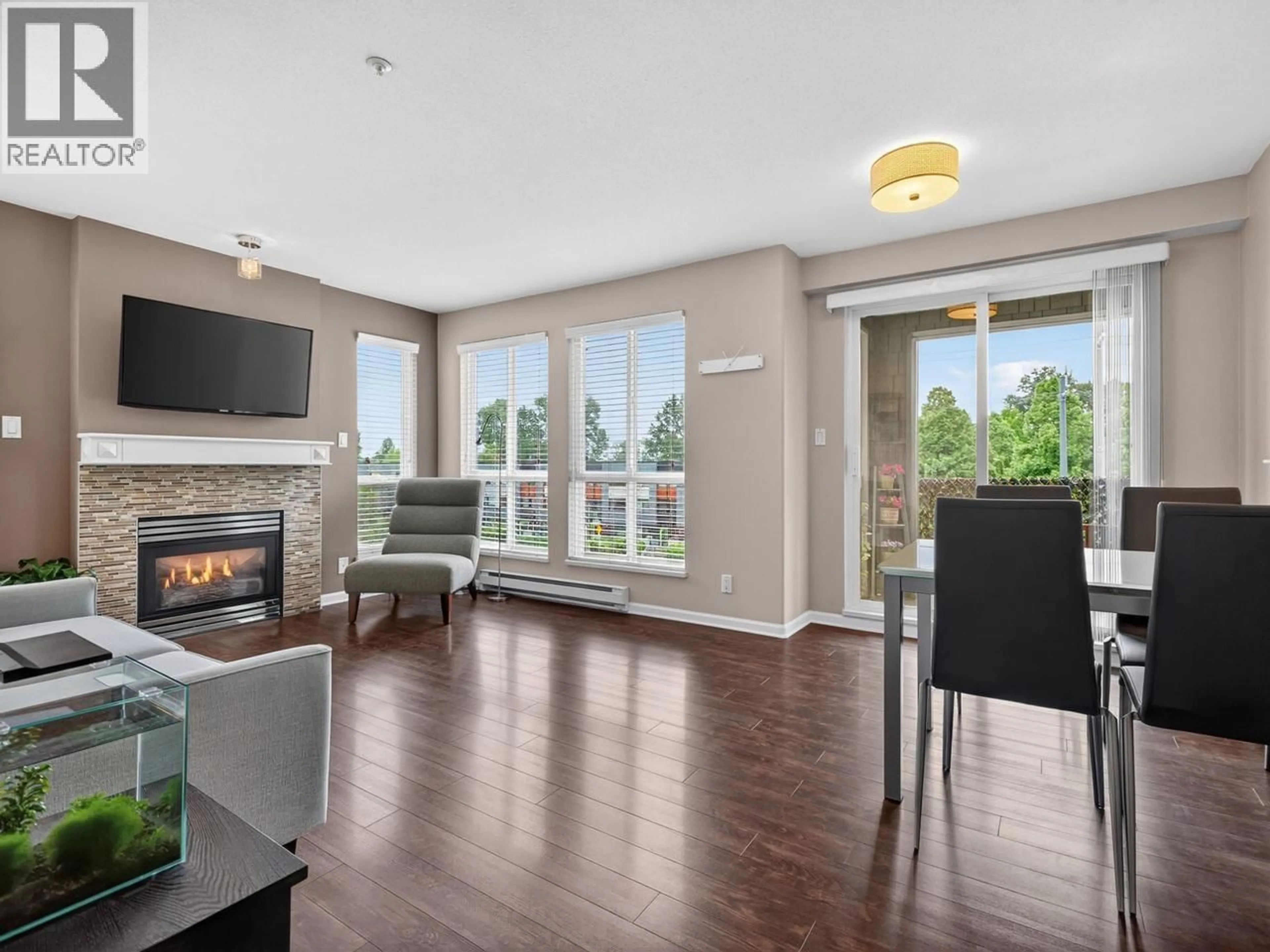 Living room with furniture, wood/laminate floor for 310 - 8495 JELLICOE STREET, Vancouver British Columbia V5S2J4