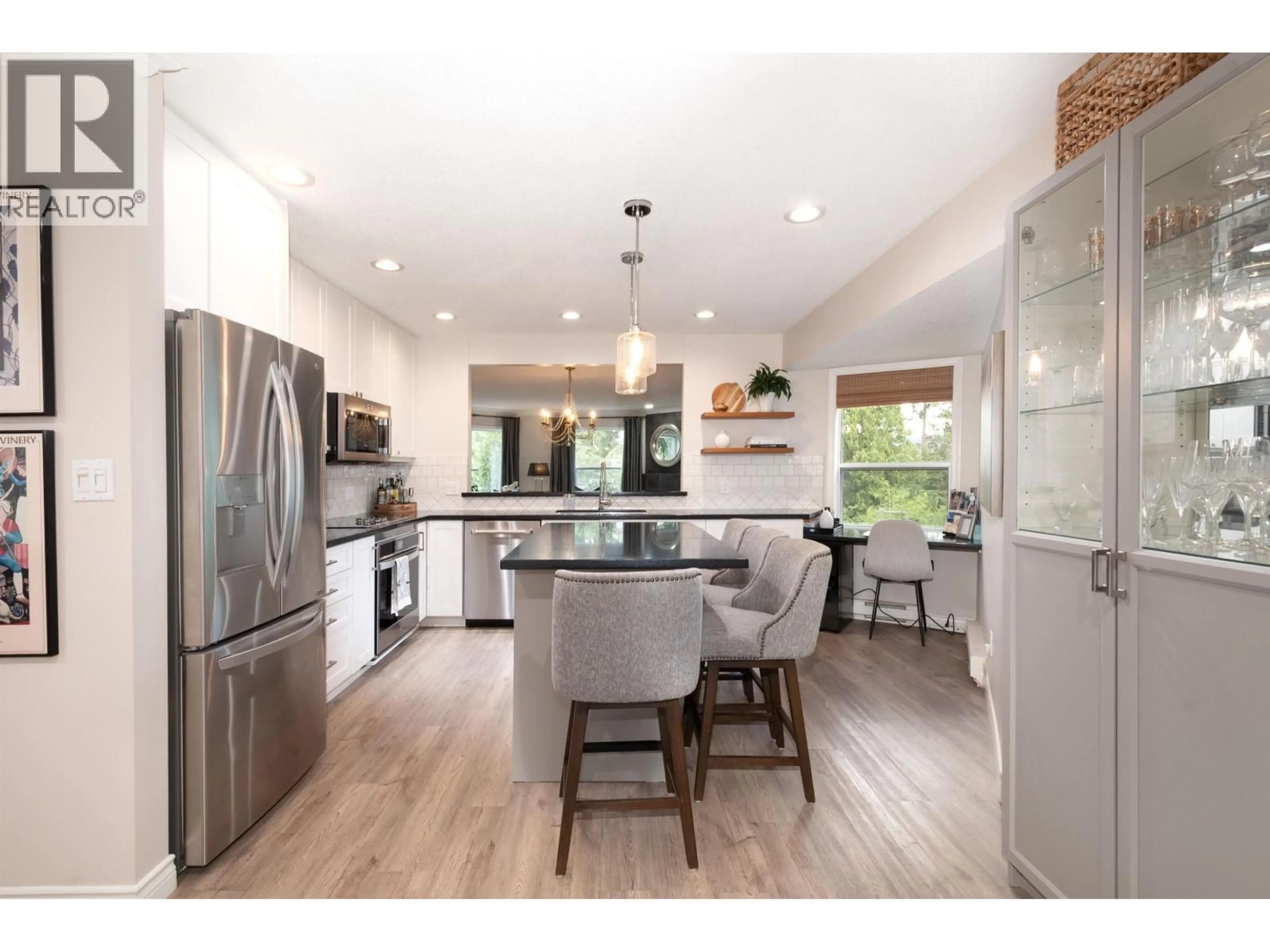 Open concept kitchen, wood/laminate floor for 706 - 1500 OSTLER COURT, North Vancouver British Columbia V7G2S2