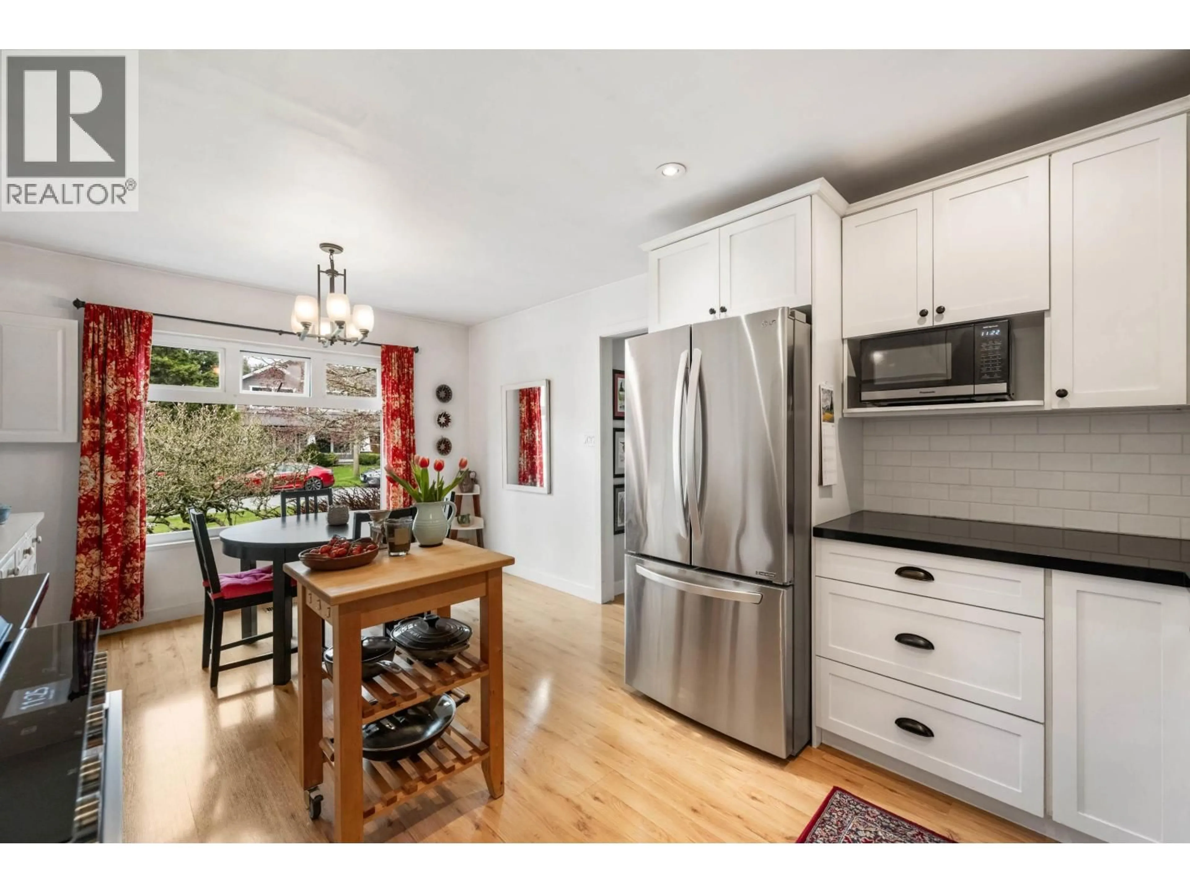 Open concept kitchen, wood/laminate floor for 4970 DOGWOOD LANE, Delta British Columbia V4M1N2