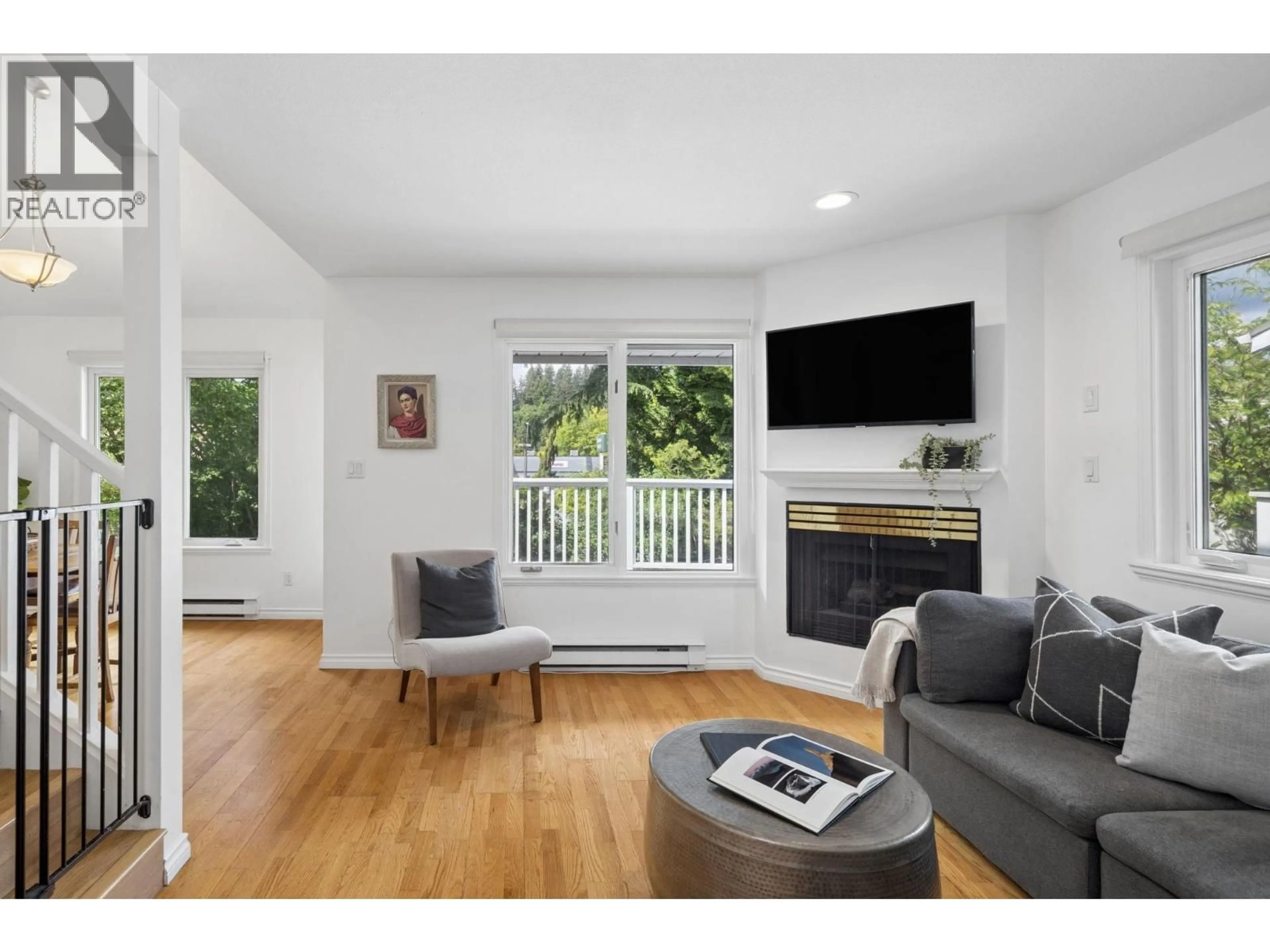Living room with furniture, wood/laminate floor for 207 - 1518 BOWSER AVENUE, North Vancouver British Columbia V7P2Y3
