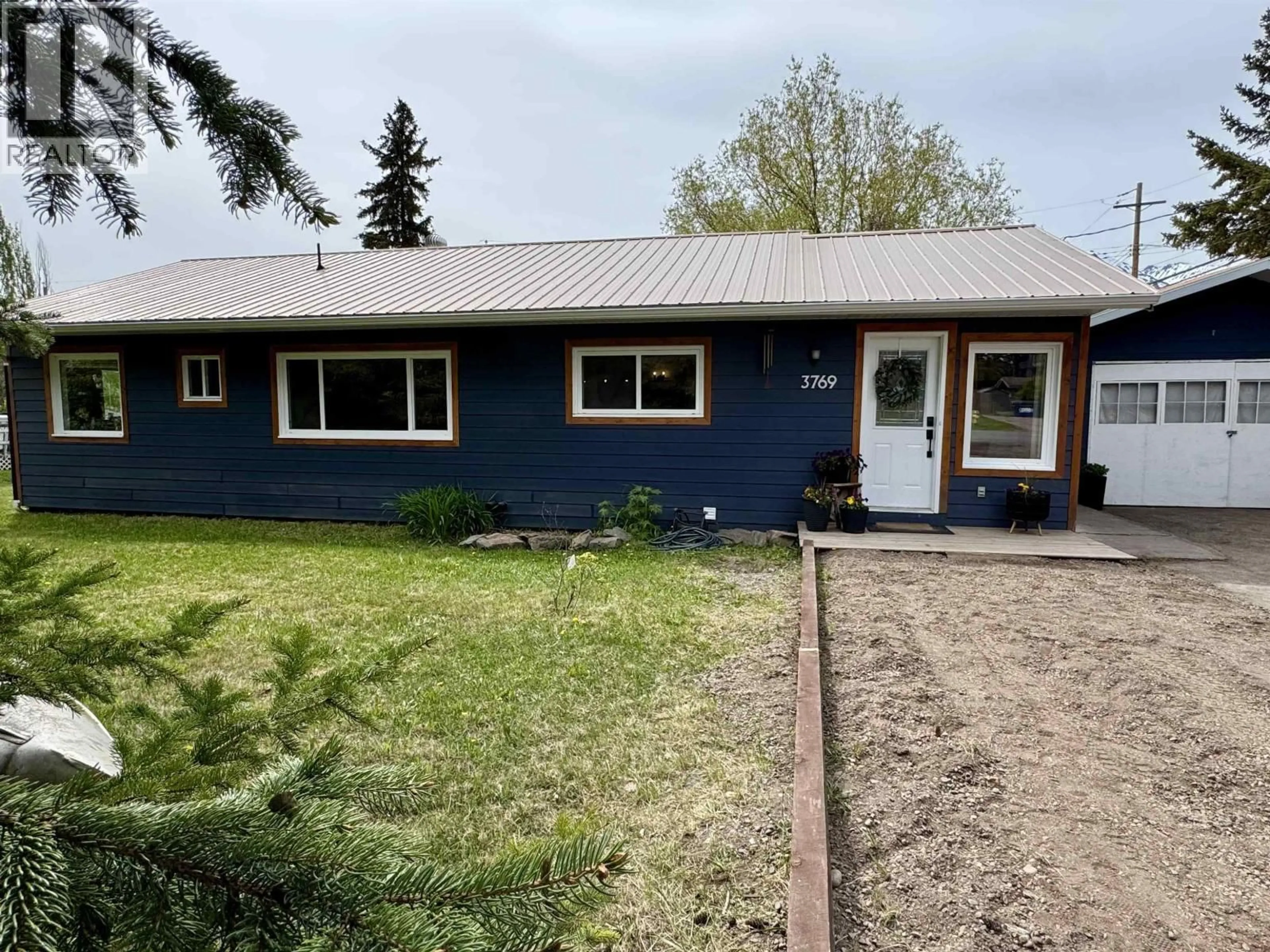 Home with vinyl exterior material, street for 3769 15TH AVENUE, Smithers British Columbia V0J2N0