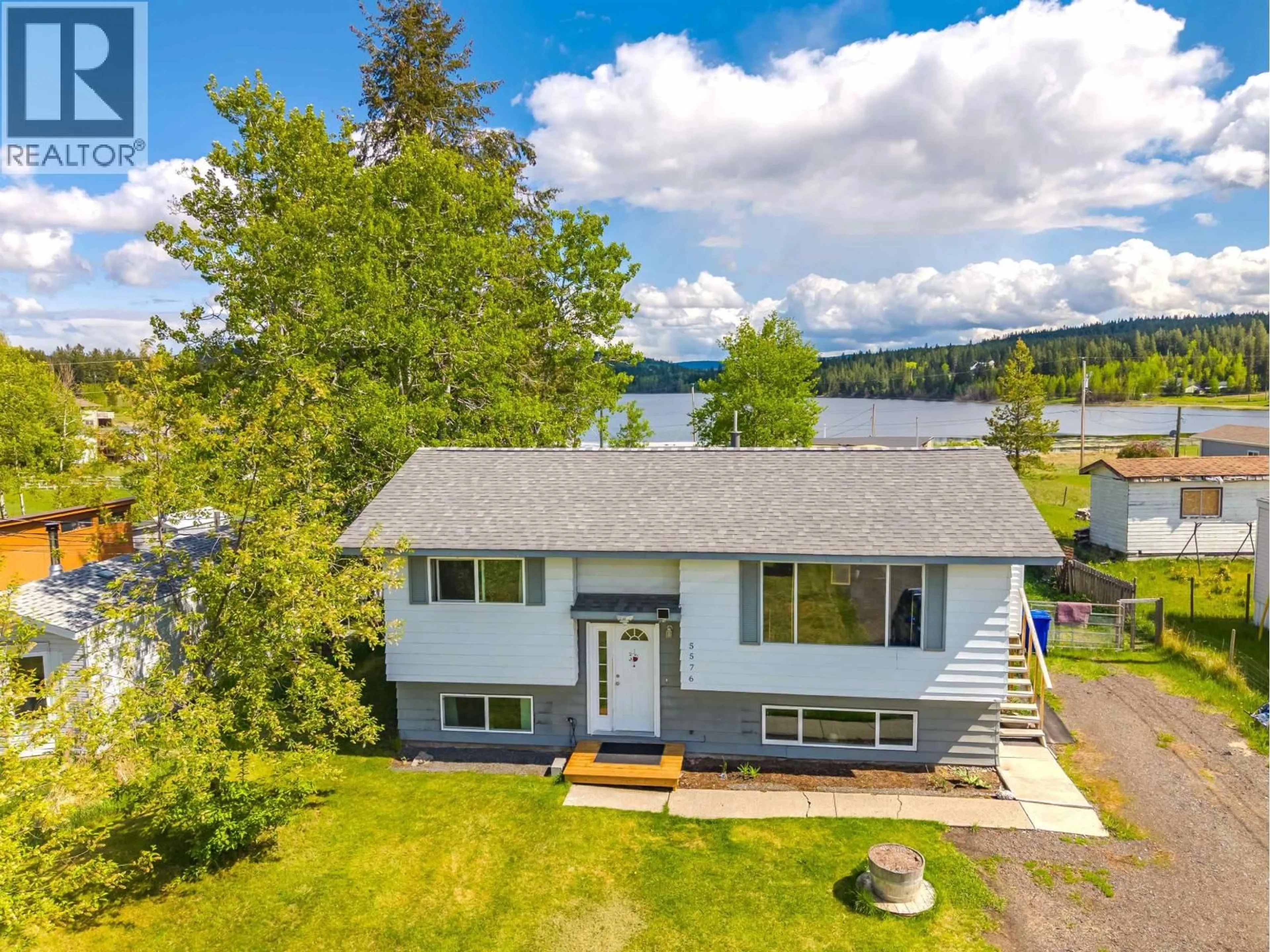 A pic from outside/outdoor area/front of a property/back of a property/a pic from drone, water/lake/river/ocean view for 5576 103 MILE LAKE ROAD, 103 Mile House British Columbia V0K2E1