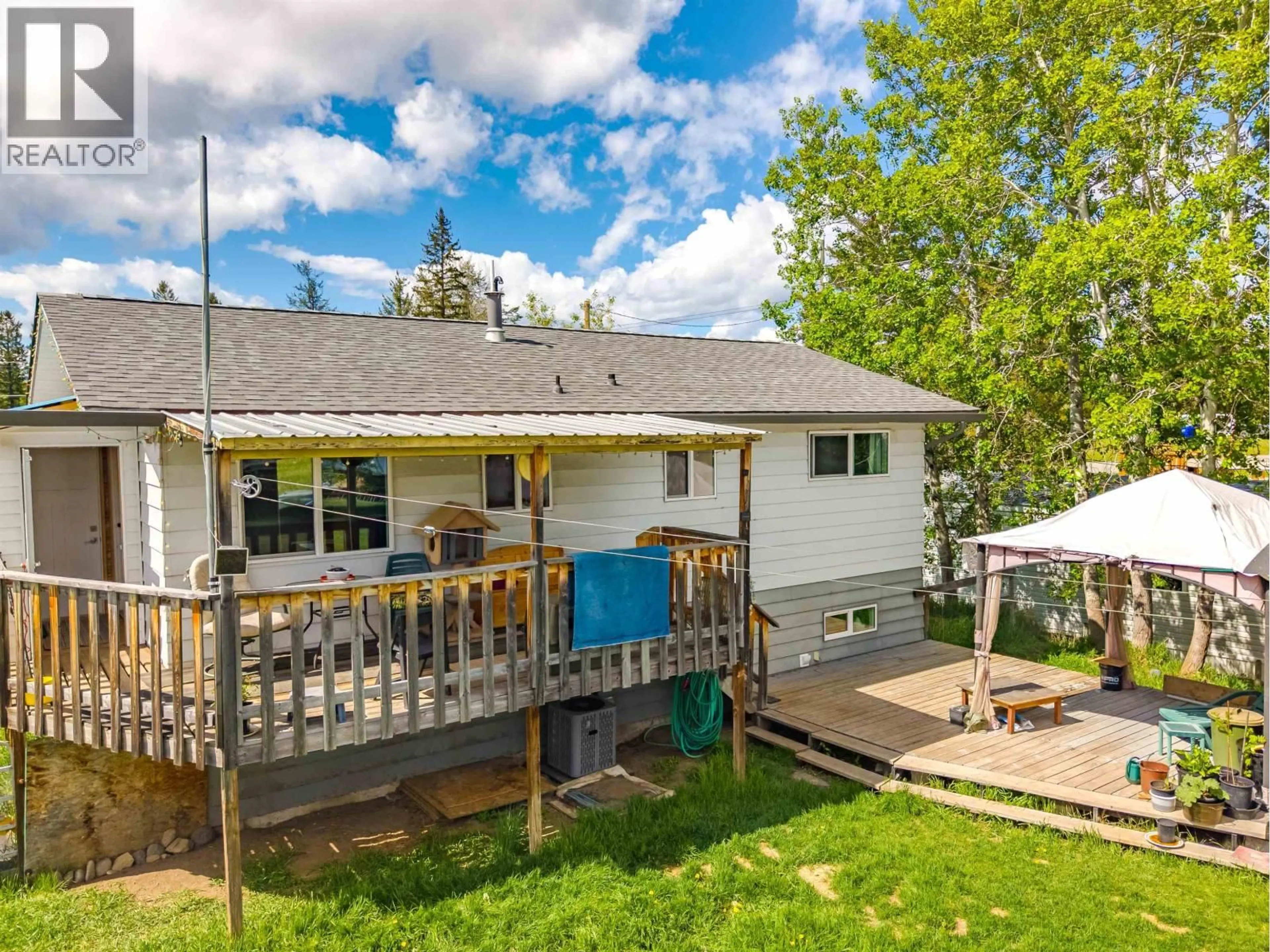 A pic from outside/outdoor area/front of a property/back of a property/a pic from drone, water/lake/river/ocean view for 5576 103 MILE LAKE ROAD, 103 Mile House British Columbia V0K2E1
