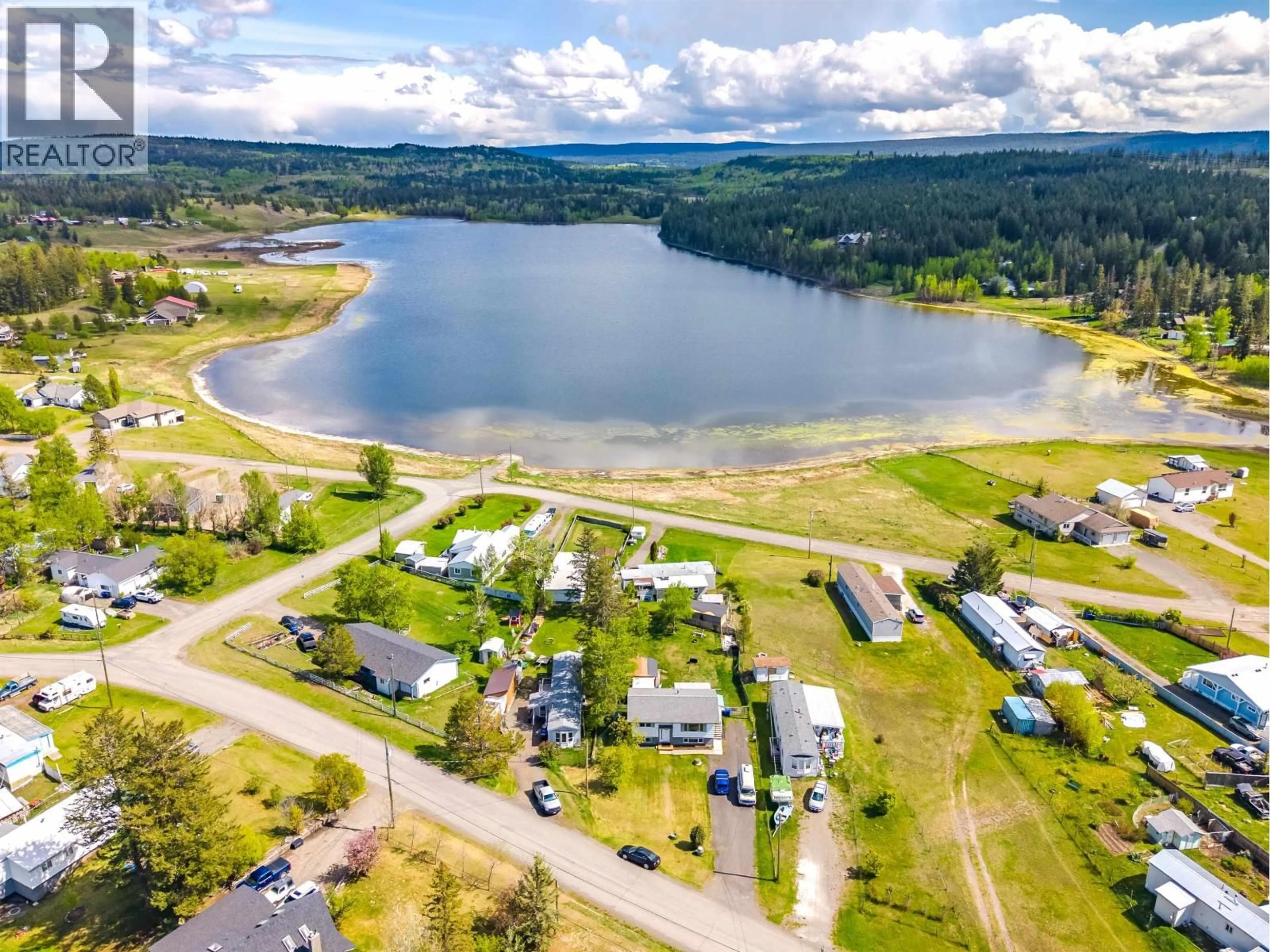 A pic from outside/outdoor area/front of a property/back of a property/a pic from drone, water/lake/river/ocean view for 5576 103 MILE LAKE ROAD, 103 Mile House British Columbia V0K2E1