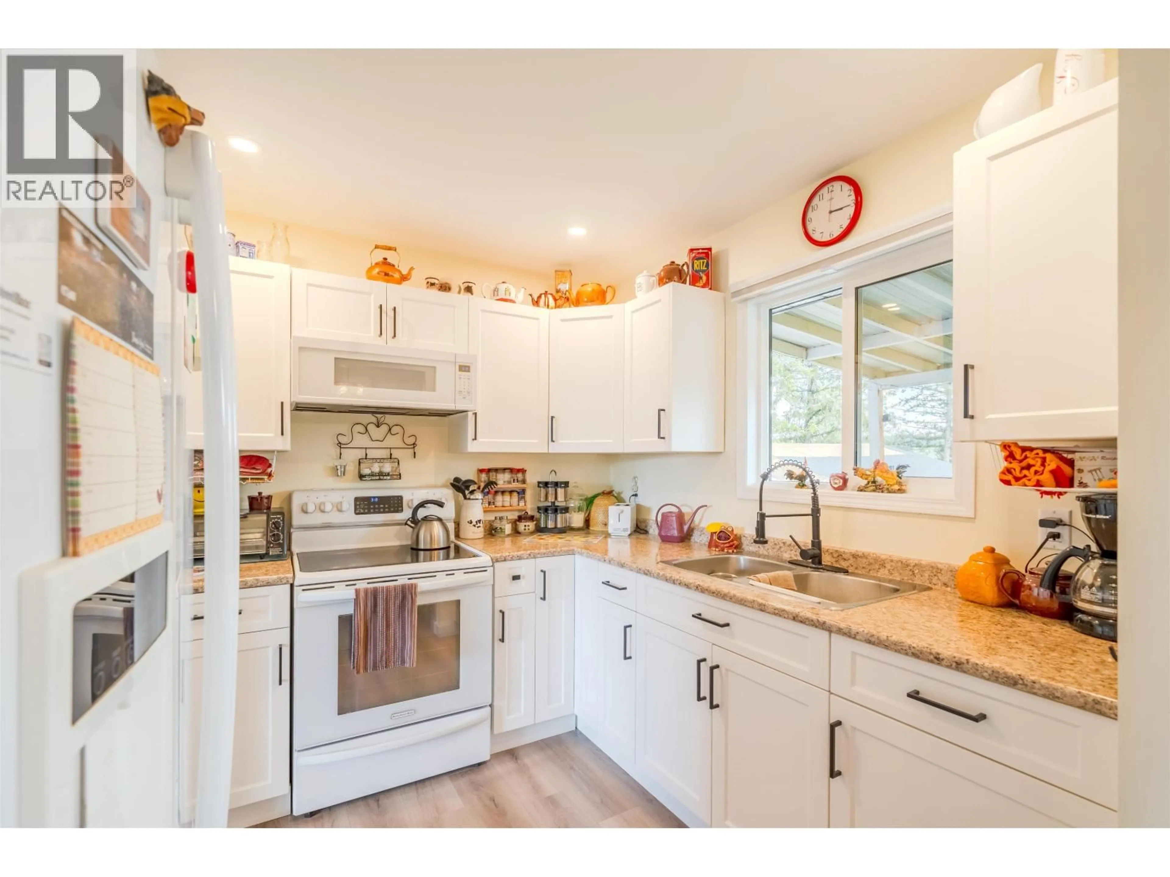 Open concept kitchen, wood/laminate floor for 5576 103 MILE LAKE ROAD, 103 Mile House British Columbia V0K2E1