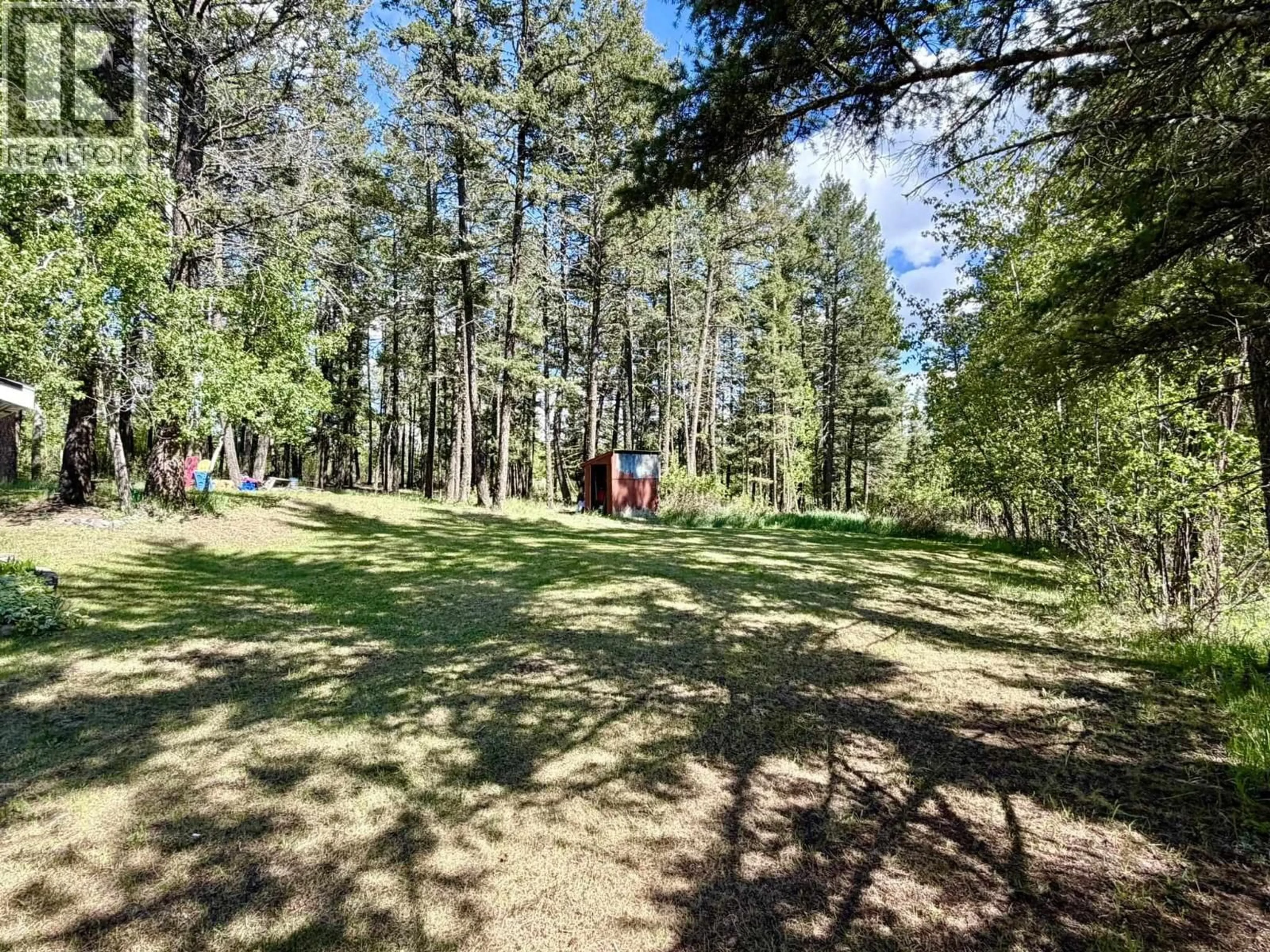 A pic from outside/outdoor area/front of a property/back of a property/a pic from drone, forest/trees view for 4833 TELQUA DRIVE, 108 Mile Ranch British Columbia V0K2Z0
