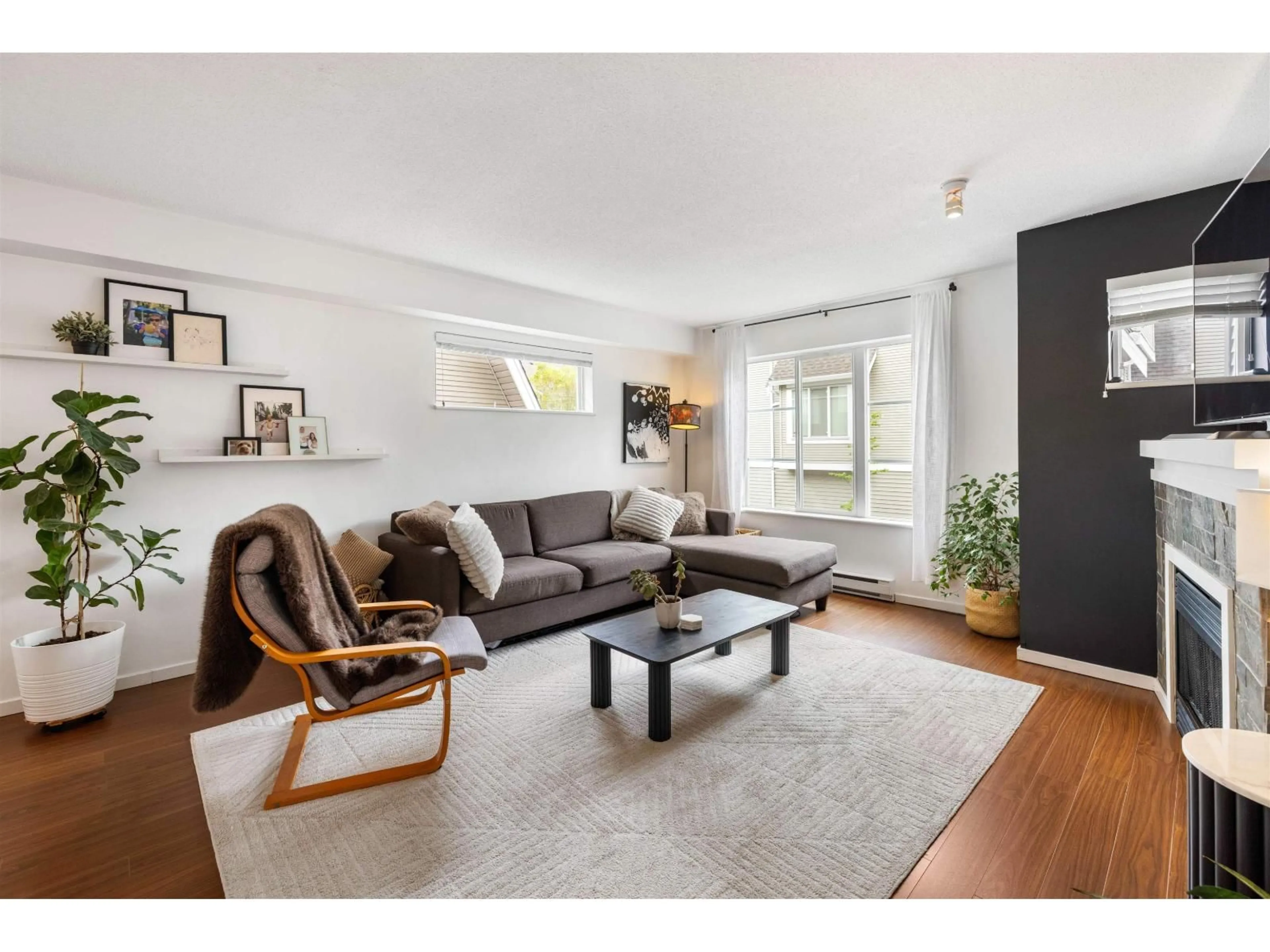 Living room with furniture, wood/laminate floor for 102 - 15175 62A AVENUE, Surrey British Columbia V3S1X1