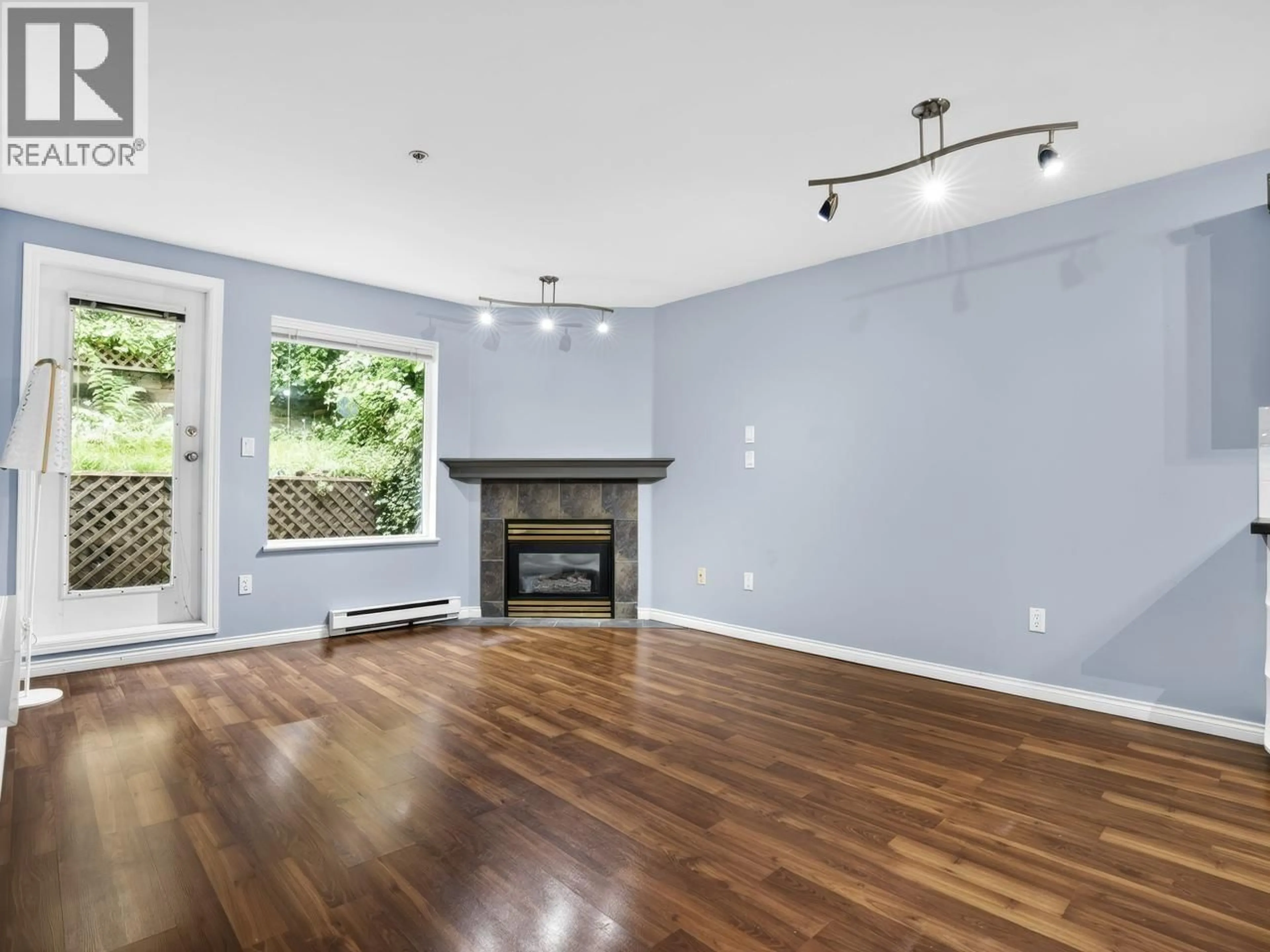 Living room with furniture, wood/laminate floor for 312 - 121 SHORELINE CIRCLE, Port Moody British Columbia V3H5G2