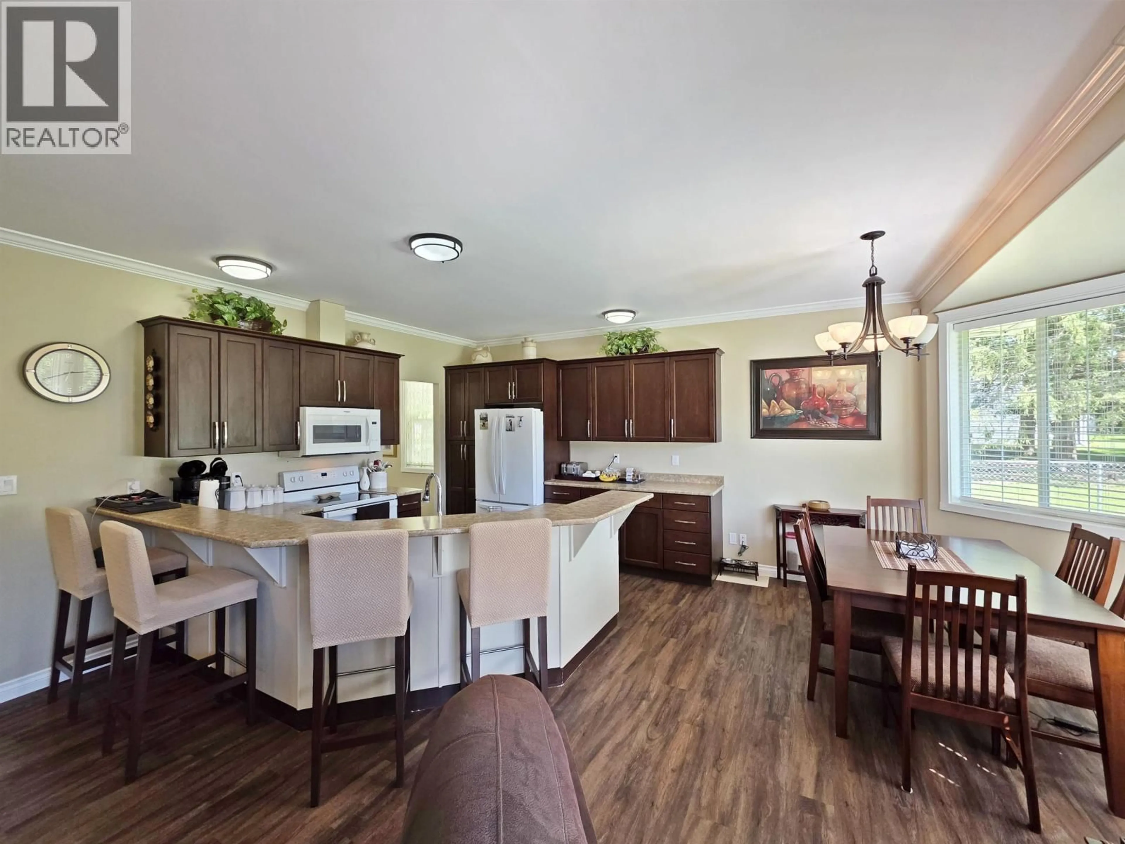 Open concept kitchen, wood/laminate floor for 1711 MAPLE DRIVE, Quesnel British Columbia V2J4A5