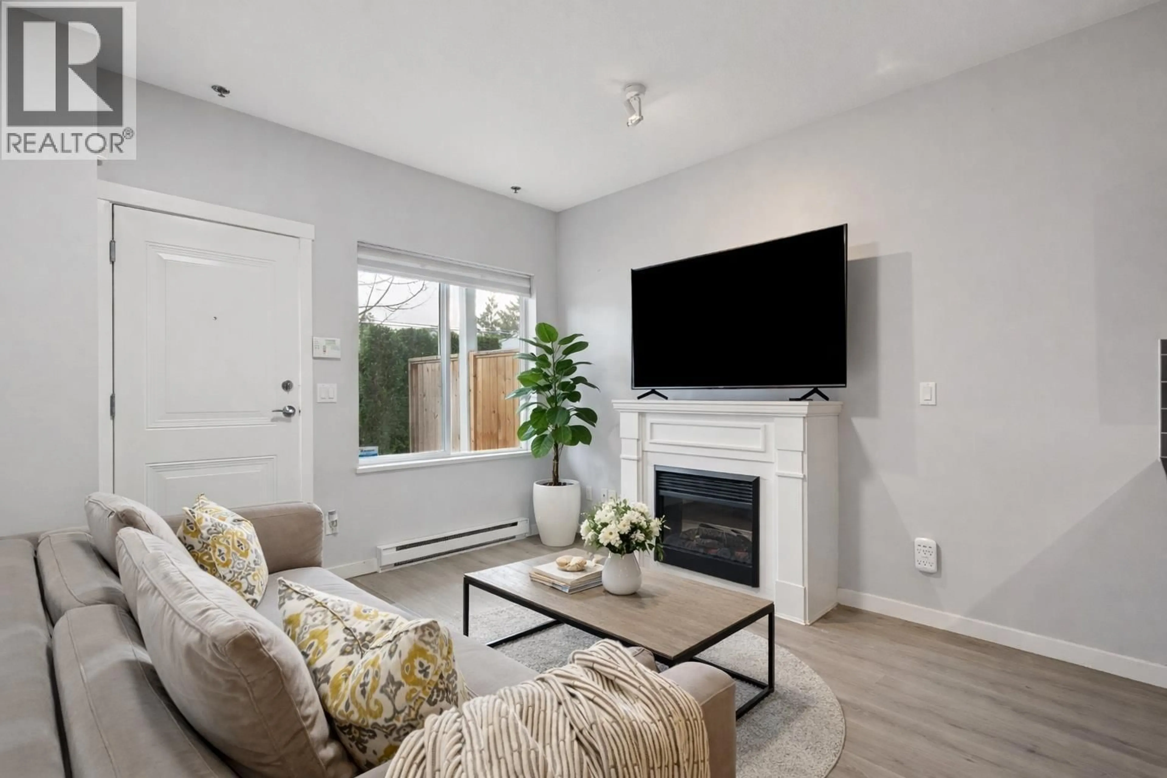 Living room with furniture, wood/laminate floor for 201 - 1661 FRASER AVENUE, Port Coquitlam British Columbia V3B0B6