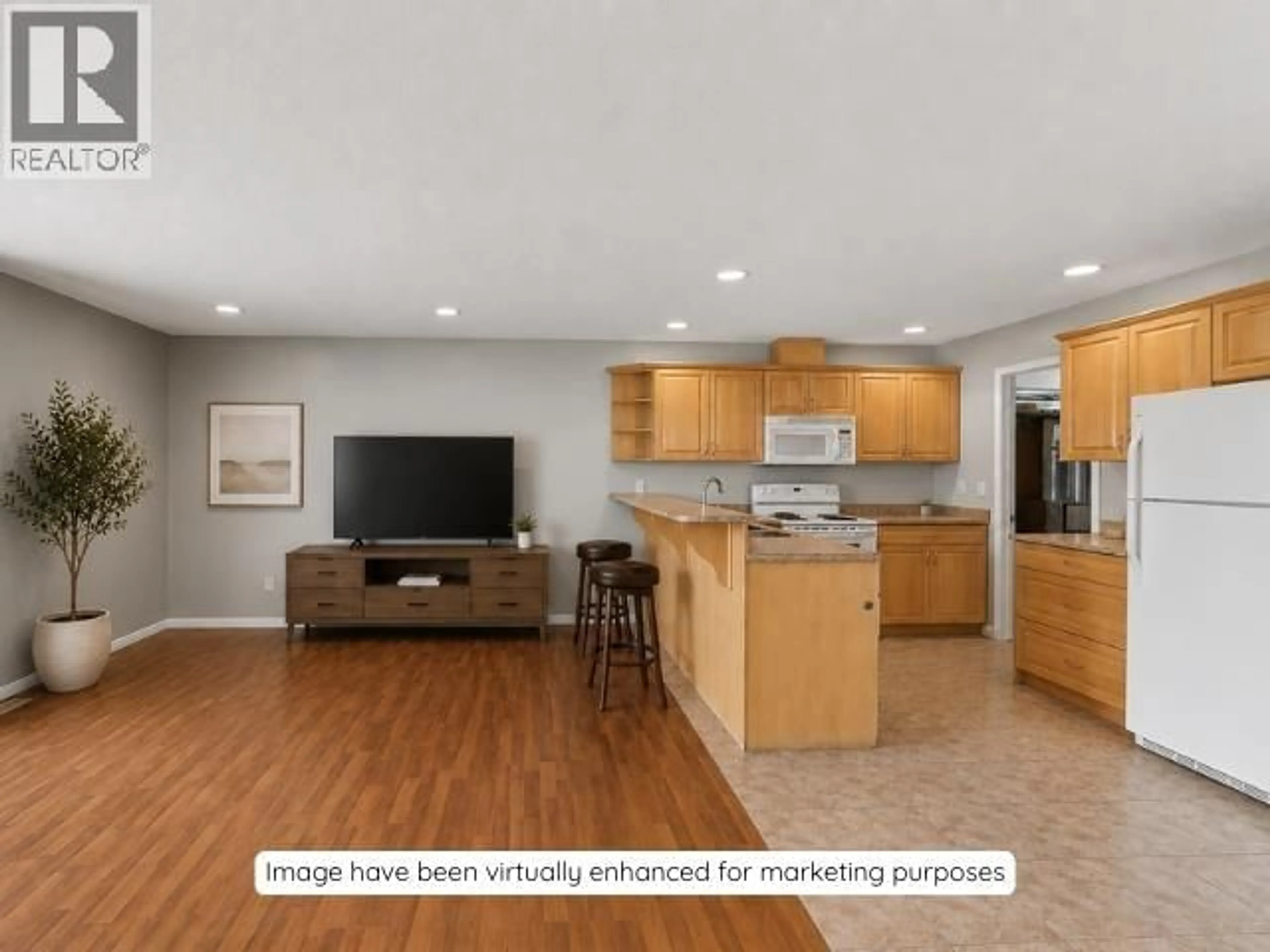 Open concept kitchen, wood/laminate floor for 9512 94 AVENUE, Fort St. John British Columbia V1J1G3