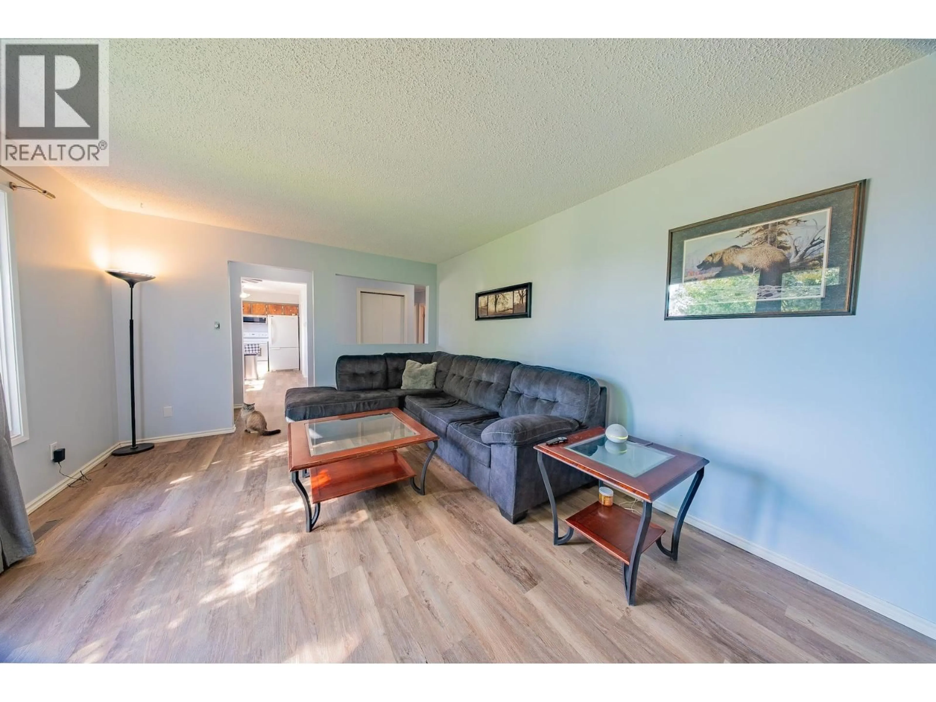 Living room with furniture, wood/laminate floor for 9107 88 STREET, Fort St. John British Columbia V1J5B3