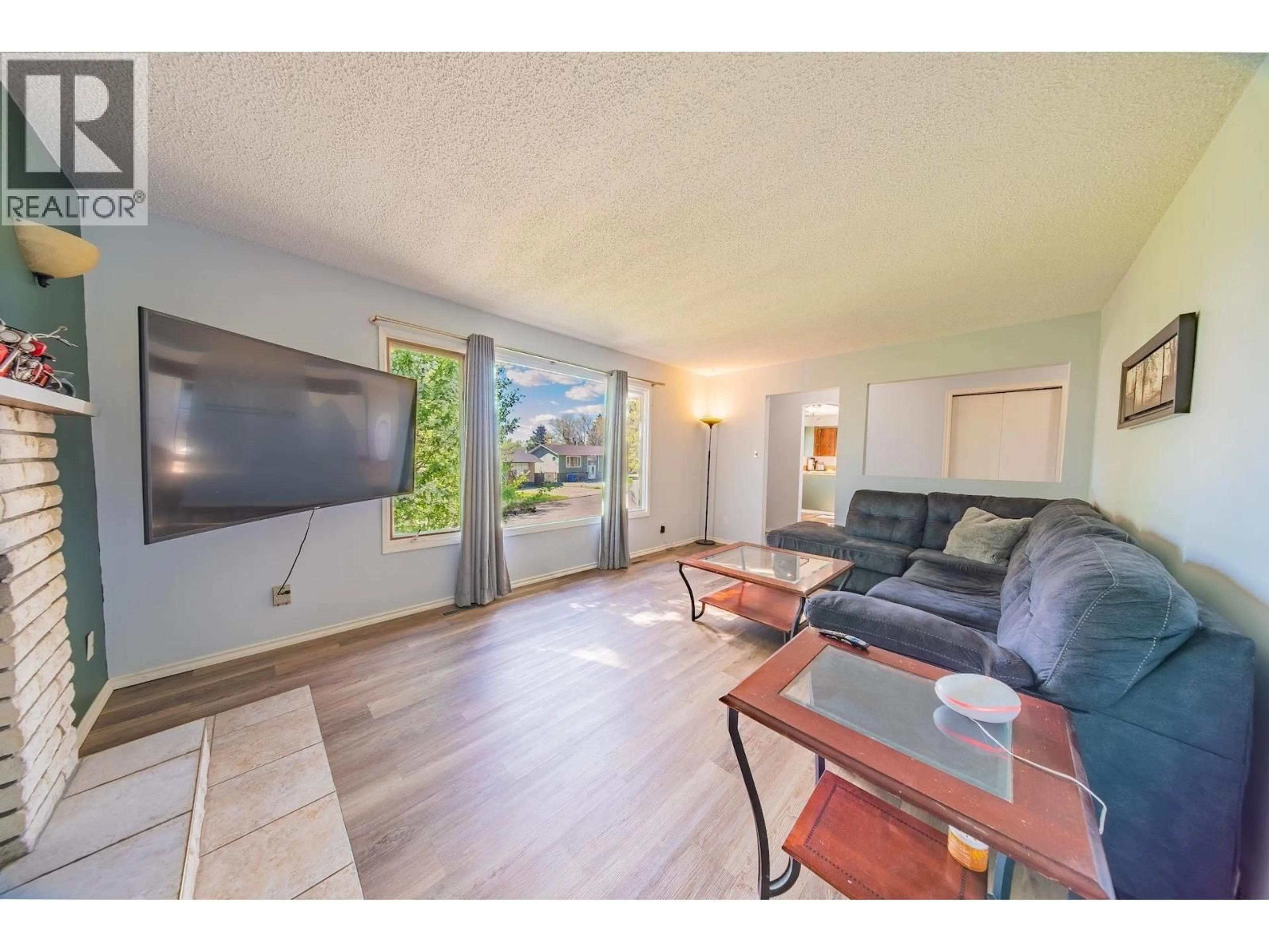 Living room with furniture, wood/laminate floor for 9107 88 STREET, Fort St. John British Columbia V1J5B3