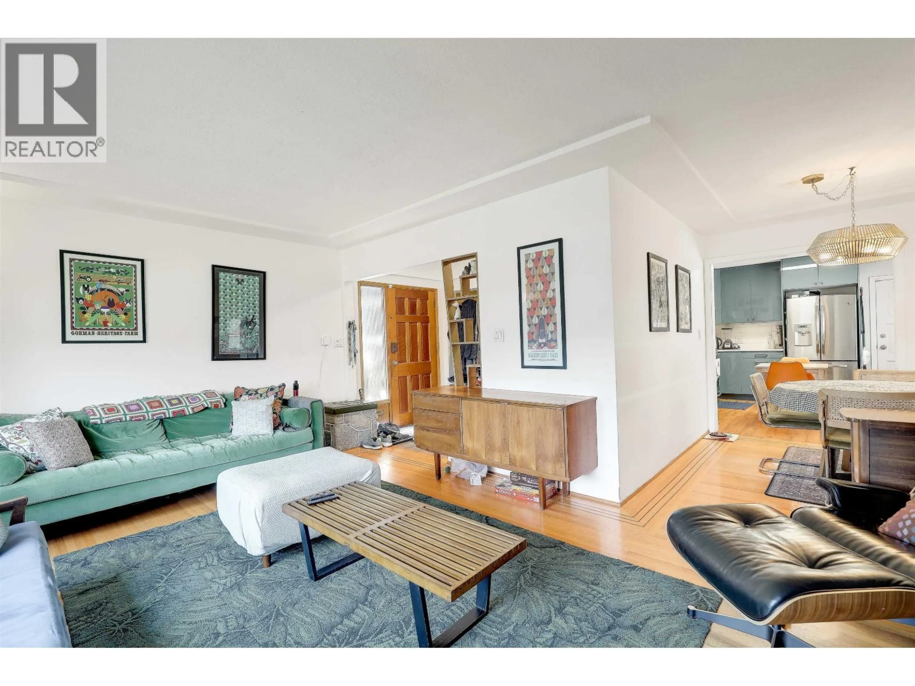 Living room with furniture, wood/laminate floor for 4139 PENDER STREET, Burnaby British Columbia V5C2M1