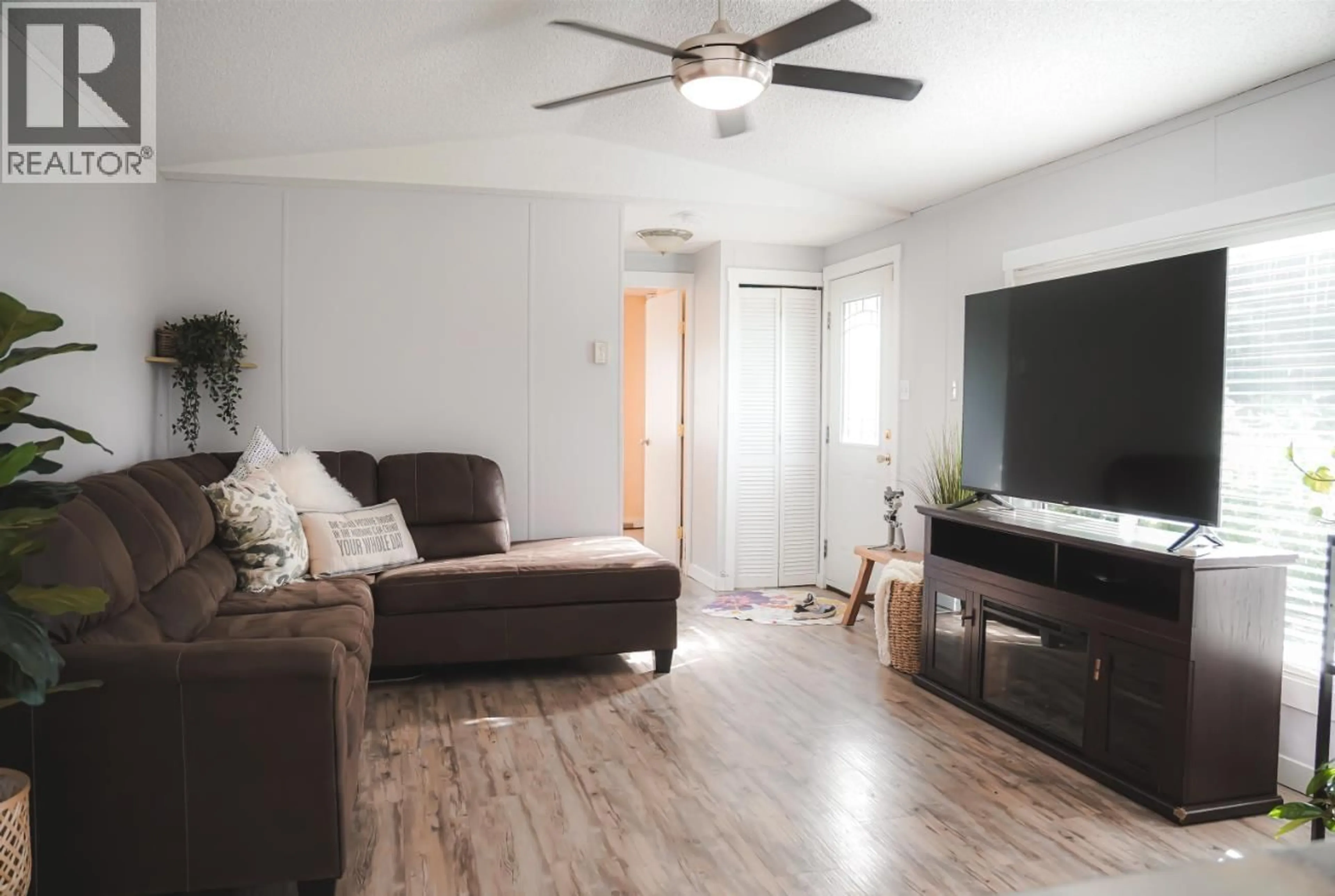 Living room with furniture, wood/laminate floor for 12478 RIMROCK DRIVE, Charlie Lake British Columbia V0C1H0