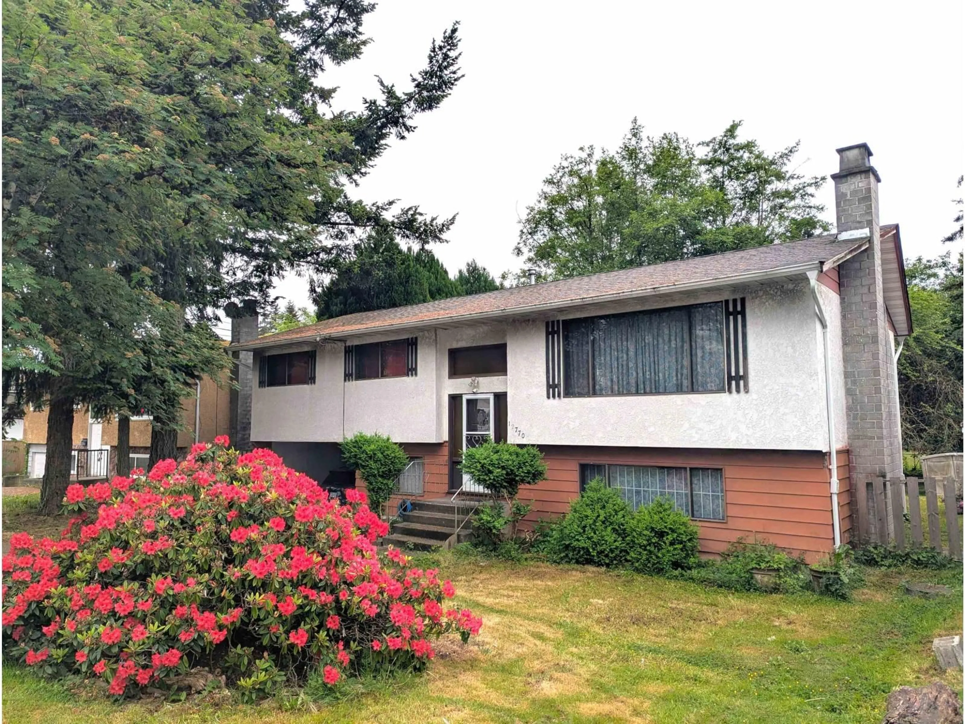 Home with vinyl exterior material, street for 12770 102 AVENUE, Surrey British Columbia V3V3E5