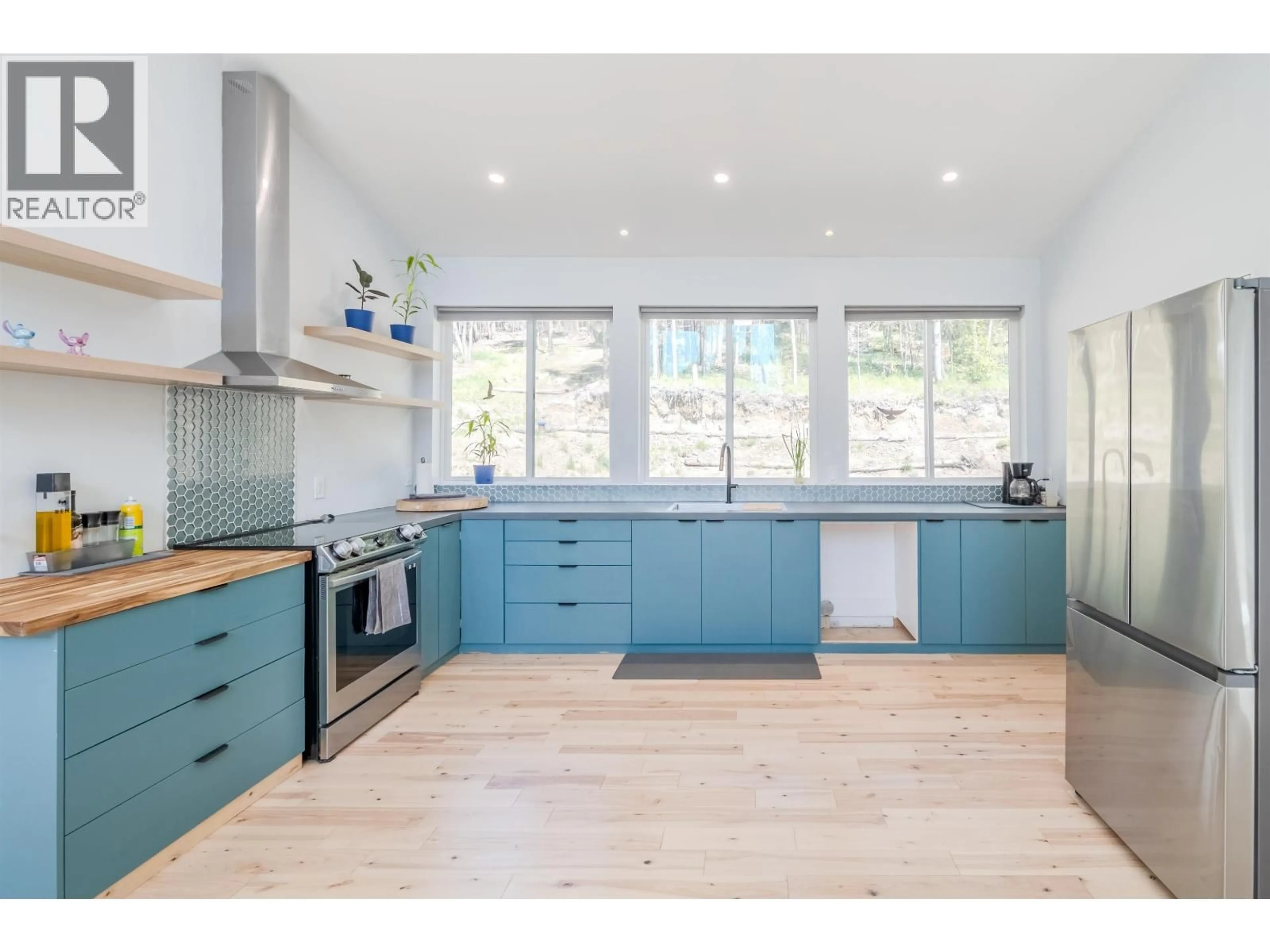 Open concept kitchen, wood/laminate floor for 6282 HILLSIDE DRIVE, Forest Grove British Columbia V0K1M0